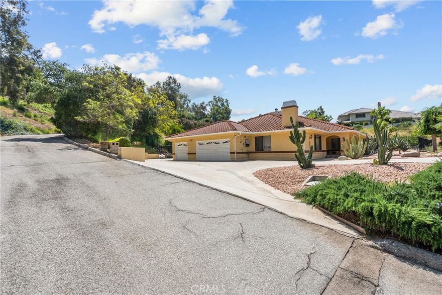 Come see this stunning single-story estate tucked away on a private road, surrounded by breathtaking mountain views. Built in 1990 and meticulously maintained by the original owner, this 4-bedroom, 4.5-bathroom home offers the perfect blend of comfort, elegance, and privacy on a spacious three-quarter-acre(approx) lot. Inside, you’ll find porcelain tile floors, vaulted ceilings, and an abundance of natural light from skylights and solar tubes. The thoughtfully designed layout includes French doors and a full laundry room complete with sink, washer, and dryer(included). The gourmet kitchen is a chef’s dream with stainless steel appliances, a Sub-Zero refrigerator, large walk-in pantry, and beautiful porcelain countertops. The oversized primary suite is a luxurious retreat featuring barn door accents, a generous walk-in closet, and a spa-like bathroom with dual vanities, a jetted tub, and a separate shower. Two additional bedrooms also offer walk-in closets, while the other features mirrored closet doors. Two bathrooms include built-in bidets. This home is packed with energy efficiency and convenience, including paid-off solar panels, dual-pane windows, newer dual HVAC systems, R-19 insulation, and 6-inch exterior walls wrapped in moisture-resistant stucco and a concrete tile roof. Additional features include a basement perfect for wine storage, 2 fireplaces, a whole-house water treatment system, interior mahogany doors, a silent MasterCentral vacuum system, and a full home security system with 8 outside cameras and four DSC Control panels with sensors and detectors in every outside door and window. Step outside to your private backyard oasis with mature fruit trees, grapevines, potted plants, multiple storage sheds, and a sparkling pool and spa. The shaded, covered patio creates an ideal space for relaxing or entertaining. This beautifully appointed estate offers exceptional value, timeless style, and the serenity of mountain living with the convenience of the city. Just waiting for you to call it home.