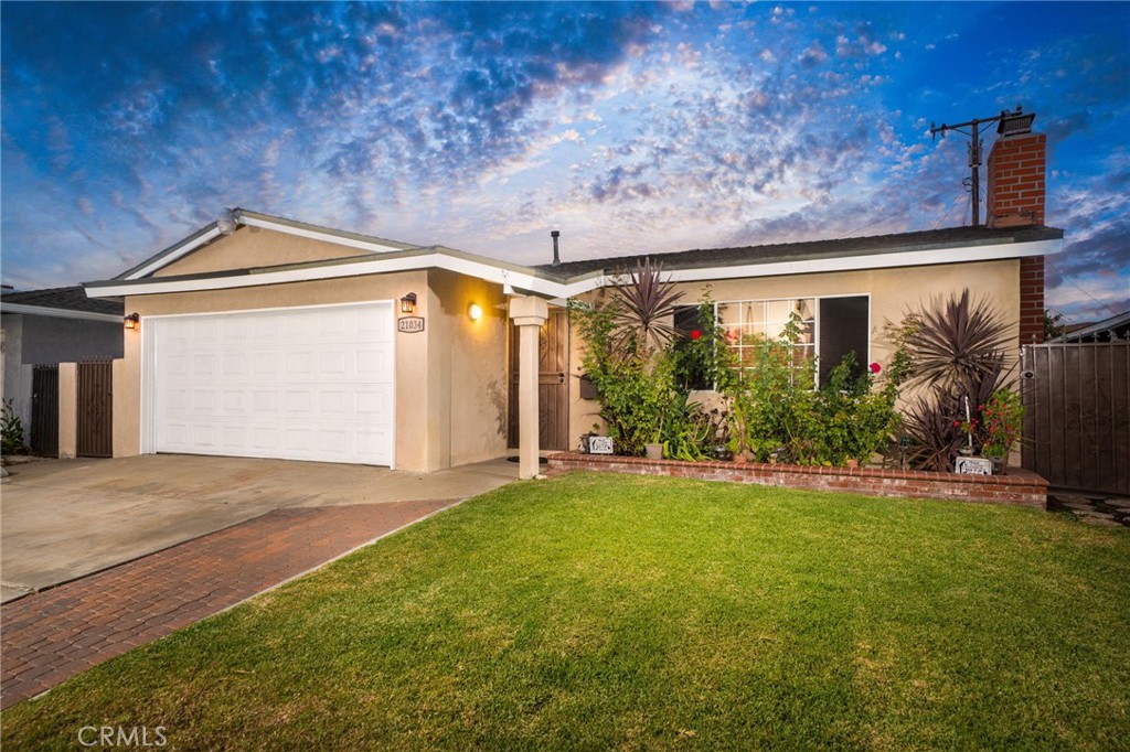 Welcome to 21034 Bolsa Street, a beautifully maintained single-story home in the heart of Carson. Offering 4 bedrooms, 2 bathrooms, and 1,512 square feet of living space on a private 5,000+ square foot lot, this residence provides the perfect balance of comfort and convenience. Inside, a bright living room with a large picture window and cozy fireplace flows seamlessly into the dining area, where a sliding glass door opens to the backyard to make indoor-outdoor living a breeze. The remodeled kitchen is a true highlight, featuring warm oak cabinetry, granite countertops, a full backsplash, stainless steel appliances, recessed lighting, and a functional peninsula for casual dining. Both bathrooms include tasteful updates that blend modern convenience with timeless character. The primary suite offers an ensuite bath and private vanity area, while three additional bedrooms provide plenty of space for family, guests, or a home office. Outside, the fenced backyard offers both grassy and paved areas, perfect for weekend barbecues, gatherings, or simply relaxing in your own retreat. An attached two-car garage and wide driveway provide ample parking and storage. The neighborhood adds even more to love, with a very walkable location near Carson Park, Anderson Park, Mills Park, and Dominguez Park, offering pools, sports courts, playgrounds, and community programs. California State University Dominguez Hills is just minutes away, along with SouthBay Pavilion Mall for shopping and dining, and Dignity Health Sports Park for LA Galaxy games, concerts, and events. With easy freeway access, beaches, downtown Los Angeles, and beyond are all within reach. More than just a house, this is a home where you can enjoy modern updates, classic charm, and a vibrant community. Don’t miss your opportunity to make 21034 Bolsa Street your own—schedule a private showing today.