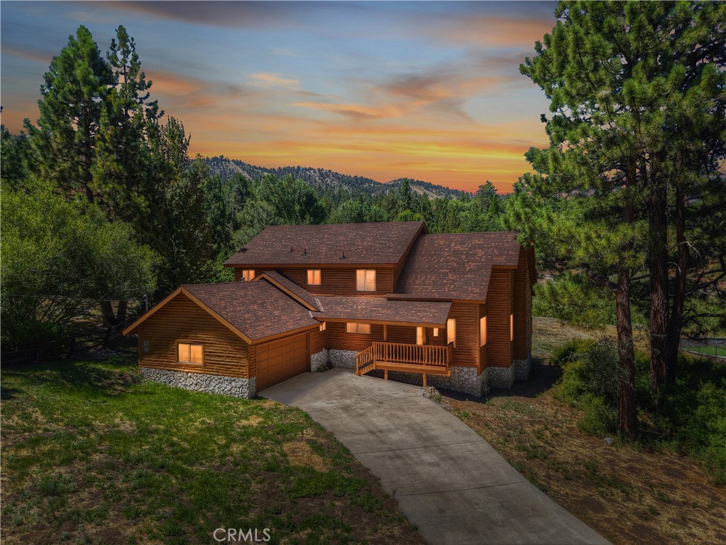 Welcome to 43611 Bow Canyon in beautiful Big Bear Lake ~ This charming mountain retreat, located in Moonridge, offers the perfect blend of rustic charm and modern amenities ~ Once you ascend the few steps to the covered front porch and open the beautifully detailed wood door you will marvel at the spacious open-concept living area, which is perfect for entertaining and spending time with friends and loved ones, and features a cozy, floor to ceiling rock fireplace, beautifully kept T&G throughout , vaulted ceilings, and lots of windows make the home light and bright and are great for taking in the stunning ski slope views ~ There are 4 large bedrooms (2 conveniently located on the main floor), 3 bathrooms and a big loft with floor to ceiling windows in this spacious 2,335 sq. ft home ~ The big kitchen offers plenty of cabinet and counter space and opens up to the living and dining rooms ~ There's also a giant walk-in pantry ~ Outside, you'll find a large deck, perfect for soaking in the fresh mountain air and gathering for drinks or BBQ, and enjoying the beautiful views ~ The property is large, almost 27,000 sq. ft., and is all flat and usable ~ There is a 2 car garage and ample parking for all your vehicles and toys ~ The roof is brand new and the outside and decks have recently been sanded down and painted ~ Located just a short drive to the lake, ski slopes, and surrounded by hiking trails, this home is the perfect base for all your Big Bear adventures ~ Don't miss out on this incredible opportunity to own your own piece of paradise in the mountains ~ This stunning property would make a wonderful primary or vacation home, and with its central location and amenities, and would be a hit on Airbnb as well!
