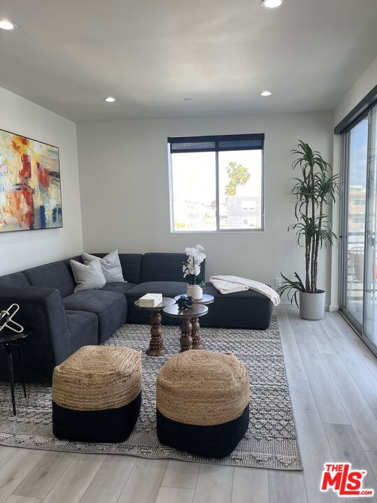 Modern top-floor corner unit in a boutique luxury building in prime Beverly Grove. This light-filled 2BD/2BA features floor-to-ceiling windows with sweeping city and mountain views. Open-concept layout with stainless steel appliances, modern stone countertops, hardwood-style flooring, and ample cabinet space. Spacious bedrooms with great separation and privacy. Includes in-unit washer/dryer, gated parking, and controlled building access. Just minutes from The Grove, Beverly Center, and some of LA's best shopping, dining, and entertainment. A rare opportunity to live in one of the city's most vibrant neighborhoods!