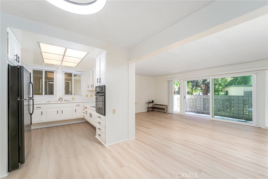 Welcome to your serene retreat in the heart of Laguna Woods Village, Southern California’s premier 55+ community. This beautifully updated Majorca Model stock cooperative offers **1,040 square feet** of thoughtfully designed living space, including 2 spacious bedrooms and 2 bathrooms. The home features dual-pane windows all around, flooding each room with natural light, and has been freshly painted and upgraded with luxury vinyl plank flooring throughout. Set in a peaceful, quiet location, this unit enjoys a bright east-facing orientation perfect for morning light and is just a short walk from the bustling clubhouses. Relax outdoors on your private patio, ideal for enjoying your morning coffee or unwinding in the evening. Inside, the layout is functional and welcoming. The kitchen and bathrooms are well-appointed, and the ground-level entry with no stairs ensures easy accessibility. Enjoy the convenience of carport parking nearby, ample storage, and community laundry just steps away. The HOA covers water, trash, cable TV, appliances, exterior building maintenance, and landscaping, offering hassle-free living. Laguna Woods Village is rich with amenities, from two championship golf courses and five sparkling pools to seven clubhouses, three fitness centers, and courts for tennis and pickleball. Creative minds will love the arts and crafts center, while nature lovers can explore the equestrian center, community garden plots, and scenic walking trails. With over 250 clubs, a performing arts theater, library, and a private community bus service, there’s always something to do. And with 24-hour gated security, peace of mind comes standard. This is your opportunity to own a turnkey home in an active, welcoming community—offering not just a home, but a lifestyle.