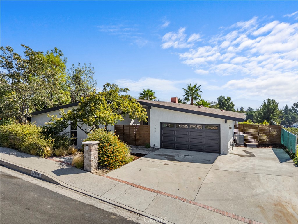 Stunning Mid-Century Modern Home in Highly Sought-After North Granada Hills
Welcome to 12648 Darla Ave, a rare, fully reimagined 4-bedroom, 2-bathroom mid-century modern masterpiece offering luxurious living in one of the Valley’s most desirable neighborhoods.
Step inside to discover a bright, open floor plan featuring a stylish living room with a floor-to-ceiling fireplace, elegant luxury vinyl flooring throughout, and large custom windows that fill the home with abundant natural light. The spacious family and dining rooms boast high vaulted ceilings, modern light fixtures, and a charming brick fireplace—creating the perfect setting for entertaining or relaxing in style.
The brand-new custom galley kitchen is a chef’s dream, showcasing high-end stainless steel appliances, quartz countertops, ample custom cabinetry, and a large walk-in pantry for added convenience. Adjacent to the kitchen, a dedicated laundry area offers additional storage and a new side-by-side washer and dryer set.
The inviting family room overlooks the beautifully landscaped backyard, ideal for gatherings, lounging, and taking in exquisite valley views. Off the kitchen, a potential fifth bedroom offers flexibility for guests, a home office, gym, or additional living space. Each of the four main bedrooms is generously sized with large closets, while the primary suite serves as a relaxing retreat with a sliding glass door leading to the backyard, allowing for easy access and abundant sunlight. Both bathrooms have been meticulously remodeled with designer finishes.
Every detail of this home has been thoughtfully curated with modern luxury and timeless design in mind—truly a showstopper property. A spacious two-car garage with direct access provides everyday convenience.
Located within the prestigious Granada Hills Charter School district and close to shopping, dining, and major freeways, this exceptional home perfectly blends style, comfort, and location.
Welcome home to 12648 Darla Ave—where mid-century charm meets modern sophistication.