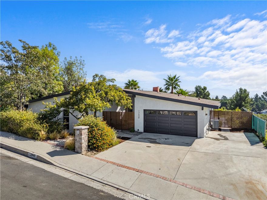 Stunning Mid-Century Modern Home in Highly Sought-After North Granada Hills

Welcome to 12648 Darla Ave, a rare, fully reimagined 4-bedroom, 2-bathroom mid-century modern masterpiece offering luxurious living in one of the Valley’s most desirable neighborhoods.

Step inside to discover a bright, open floor plan featuring a stylish living room with a floor-to-ceiling fireplace, elegant luxury vinyl flooring throughout, and large custom windows that fill the home with abundant natural light. The spacious family and dining rooms boast high vaulted ceilings, modern light fixtures, and a charming brick fireplace—creating the perfect setting for entertaining or relaxing in style.

The brand-new custom galley kitchen is a chef’s dream, showcasing high-end stainless steel appliances, quartz countertops, ample custom cabinetry, and a large walk-in pantry for added convenience. Adjacent to the kitchen, a dedicated laundry area offers additional storage and a new side-by-side washer and dryer set.

The inviting family room overlooks the beautifully landscaped backyard, ideal for gatherings, lounging, and taking in exquisite valley views. Off the kitchen, a potential fifth bedroom offers flexibility for guests, a home office, gym, or additional living space. Each of the four main bedrooms is generously sized with large closets, while the primary suite serves as a relaxing retreat with a sliding glass door leading to the backyard, allowing for easy access and abundant sunlight. Both bathrooms have been meticulously remodeled with designer finishes.

Every detail of this home has been thoughtfully curated with modern luxury and timeless design in mind—truly a showstopper property. A spacious two-car garage with direct access provides everyday convenience.

Located within the prestigious Granada Hills Charter School district and close to shopping, dining, and major freeways, this exceptional home perfectly blends style, comfort, and location.

Welcome home to 12648 Darla Ave—where mid-century charm meets modern sophistication.
