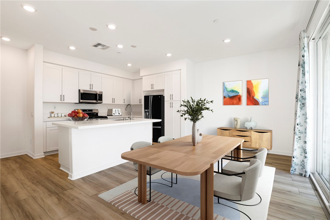 Welcome to this stunning, newly constructed townhouse-style condo located in the heart of La Puente. Built in 2024, this desirable end-unit offers an abundance of natural light and modern design throughout. The main level features a stylish kitchen equipped with stainless steel appliances, white quartz countertops, and a center island that opens to the dining area and a private balcony—perfect for entertaining. The adjacent living room boasts recessed lighting and sleek laminate flooring, creating a warm and inviting space. Upstairs, the spacious primary suite includes a dual-sink vanity, private water closet, large walk-in shower, and a walk-in closet. The secondary bedroom also features its own ¾ bathroom for added comfort and privacy. Additional highlights of this home include: Attached two-car garage with direct access, owned solar panels for energy efficiency, custom window blinds, convenient guest powder room, stackable washer and dryer, tankless water heater, ample storage throughout, close proximity to guest parking. With a low HOA of just $319/month, this home is ideally situated near Sunshine Park, 99 Ranch Market, and offers easy access to the 60 Freeway. Don’t miss your chance to own this move-in-ready gem. A must-see to truly appreciate!