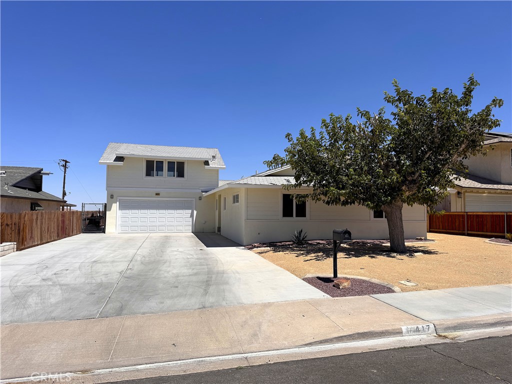Stunning 4-Bedroom, 3-Bath Home with Pool and Guest Quarters in a Prime Barstow Location.This beautifully remodeled two-story home is nestled in one of Barstow’s most desirable neighborhoods and offers the perfect blend of comfort, style, and flexibility. Inside, you'll find four spacious bedrooms and three fully updated bathrooms, including two en suite bedrooms—one on each level—making it an ideal layout for multi-generational living or hosting long-term guests. The heart of the home is the open-concept kitchen, complete with crisp white cabinetry, Corian countertops, stainless steel appliances, and a breakfast bar that flows seamlessly into the living space. The living room features a contemporary wood-burning fireplace insert and durable wood-grain hard surface flooring that runs throughout the entire home, tying each room together with a cohesive, modern look. Step outside into a backyard designed for enjoyment and entertainment. A sparkling in-ground pool with a slide sets the stage for summer fun, while a large deck and charming gazebo provide the perfect backdrop for relaxing or hosting friends and family. The fully fenced yard offers both privacy and space, and the landscaped front yard—with a mature shade tree and oversized driveway—adds to the home's curb appeal. One of the standout features is the private guest quarters located above the garage. This self-contained space includes a bedroom, full bathroom with custom tilework, a beautiful vanity, and its own kitchenette—ideal for in-laws, visitors, or even rental income. Conveniently located just minutes from shopping and freeway access, this home is less than a mile from I-15 and I-40, and only a short drive to local stores like Stater Bros. and Super Walmart. Whether you're looking for a comfortable family home or a flexible living arrangement with room for guests, this property truly has it all.