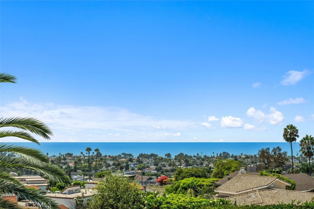 BREATHTAKING VIEWS—from the Pacific Ocean and Catalina Island to Dana Point & sparkling city lights-- from nearly every room of this stunning CUSTOM ESTATE in San Clemente’s prestigious Harbor Estates. Set on a premier homesite, with approx. 4,836 sq. ft, this beautiful home features 4 spacious bedrooms and 4 baths, including a private main-level ensuite in-laws quarters that guests will enjoy as well. A dramatic 22-ft entry with a sweeping staircase and custom glass doors sets the tone for elegant living. Grand living and dining areas open to ocean vistas, while the cozy family room and breakfast nook continue the theme of endless views. Upstairs, a bonus room with bar and deck is perfect for entertaining, and the luxurious primary suite features a private balcony and spa-inspired bath. Exquisite craftsmanship shines throughout with marble and hardwood floors, crown moldings, and custom windows. Never worry about power outages, since this magnificent home comes equipped with a whole-house generator. Another bonus there are NO HOA fees! Outside, enjoy a RESORT-STYLE BACKYARD, with a pool, spa, cabana that includes a built-in BBQ, smoker, granite counters, and a 3/4 bath. Manicured landscaping, a 5-hole putting green, a stone entry patio, and a stunning sunset views complete the picture. Located just minutes from top rated schools, beaches, shopping, dining, and recreation-- this is COASTAL LUXURY at its finest!