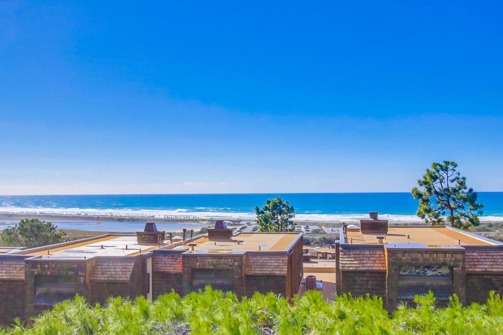 Enjoy SPECTACULAR 180-degree WHITEWATER OCEAN VIEWS from this beautiful Sea Village townhome located in coastal Del Mar. Lovingly renovated, this 1,668 sq. ft. 2-bedroom + office/loft, 2.5-bath residence offers a direct-access 2-car garage (w/ tons of storage space), private gated courtyard entryway, spacious balcony & patio. The chef’s kitchen features luxurious high-end appliances, including a Wolf gas stove, oven & microwave, Sub-Zero counter-depth refrigerator & wine fridge, Miele dishwasher, Brazilian quarried stone countertops, Blanco sink, custom wood & glass cabinetry & soft-close drawers. Whole-home upgrades include luxury vinyl plank flooring, HVAC, baseboards & fresh paint. The powder & secondary baths have been exquisitely remodeled. Exterior renovations include stunning custom sliding doors & screens, motorized shades, skylights, windows & a spacious balcony w/ Trex decking. Additional renovations include a lovely remote-controlled gas fireplace w/ fire glass & porcelain surround, custom front door & entryway, soundproofing, drywall w/ hand-textured stucco, custom lighting & wood stairways w/ beautiful wrought iron railings. Sea Village is an impeccably maintained community that offers homeowners such outstanding private amenities as two pools & spas, two lighted tennis courts, BBQ areas, putting green & a tot lot. Located just a short stroll to the sands of world famous Torrey Pines State Beach, Torrey Pines State Reserve Extension, as well as to many restaurants & a coffee house, this is southern California beach living at its finest!