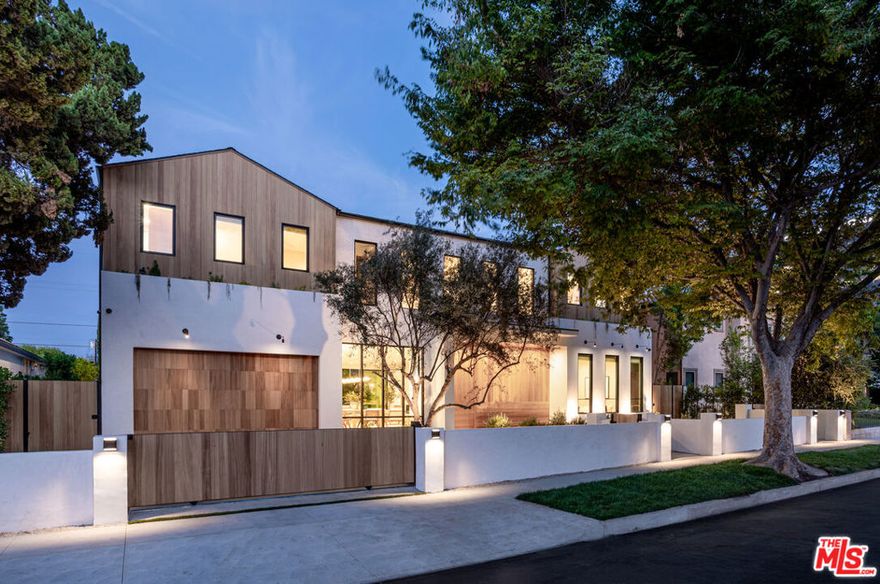 BACK ON THE MARKET (buyer could not perform) A one-of-a-kind, perfectly curated new construction tucked away on a quiet cul-de-sac in one of Encino's premier locations. This superior estate masterfully blends cutting-edge amenities with warm, organic design elements, delivering elevated comfort and refined living throughout. An expansive open floor plan with soaring ceilings is drenched in natural light, creating a seamless flow for everyday living and entertaining. The exquisite chef's kitchen is a showpiece, featuring an oversized center island with breakfast seating, top-of-the-line Thermador appliances, and custom-built oak cabinetry. The main level also offers a spacious home office and a fully equipped movie theater ideal for unforgettable family movie nights. The luxurious primary suite is a private retreat, showcasing a massive walk-in closet and a spa-like bathroom with a soaking tub, walk-in shower, dual vanities, and a serene enclosed patio perfect for relaxation. Designed for superior entertaining, the backyard features a sparkling pebble-tech pool and spa with a beautiful water feature, generous grassy area, built-in BBQ, and an inviting fire-pit lounge. The home is fully gated for maximum privacy and is equipped with a Control4 smart system, solar panels, surround sound, and security cameras throughout offering the ultimate in modern, luxury living.