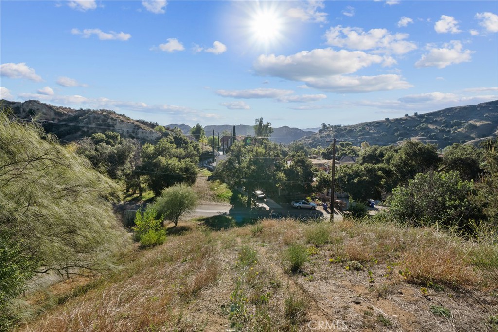 Prime opportunity to own this expansive, nearly 0.4-acre VIEW lot in Val Verde, offering a blend of rural tranquility and city proximity. Enjoy panoramic mountain vistas just minutes from Santa Clarita Valley, Magic Mountain, and Castaic Lake.
Conveniently located with easy access to Hwy 126, Interstate 5, and Ventura beaches. This exceptional lot includes completed soil and geology report, a previously passed percolation test for septic, with utilities (water and power) available at the street.
The Val Verde community amenities feature hiking trails, a community center, park, BBQ areas, swimming pool, sport courts, soccer fields, and seasonal concerts.
This versatile lot offers the perfect canvas to build your dream home or develop an income-generating property. Its favorable location and available utilities, make it ideal for residential construction or future investment.
Buyer is advised to verify all information to their satisfaction.