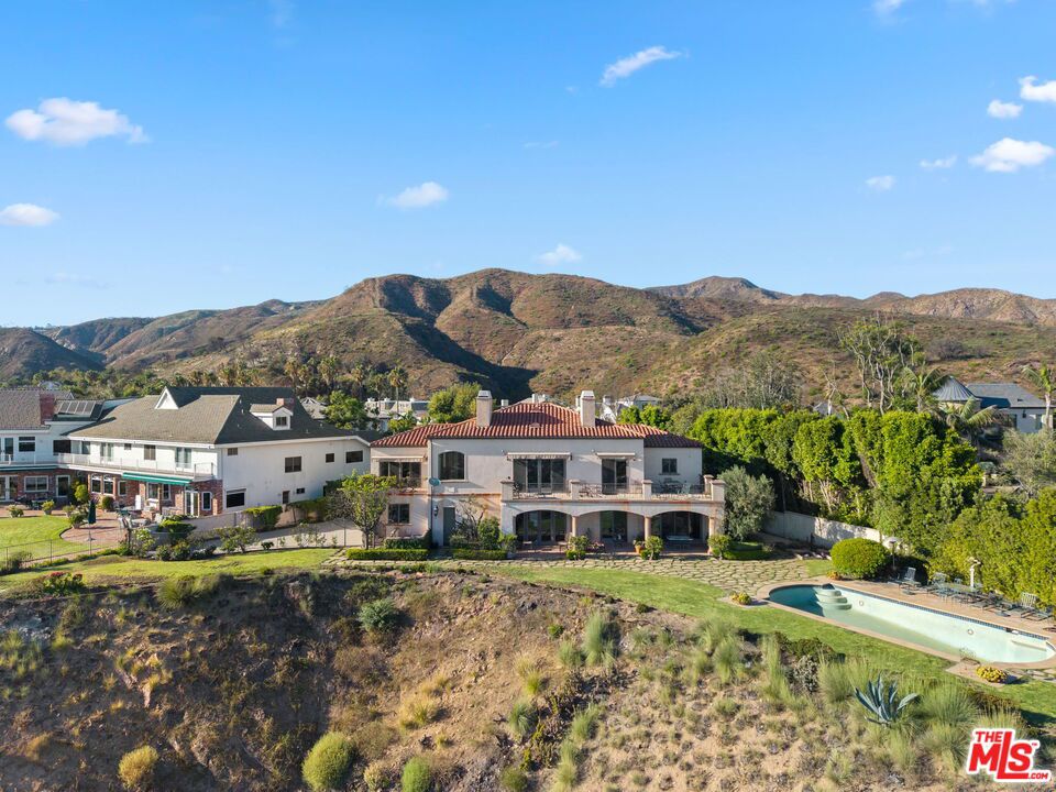 With views from the ocean to the sea, this is a premiere Ridgeview Country Estates Residence. Located behind the 24 hour guard-gates of the Ridgeview Country Estates, this beautifully remodeled home (2001) blends sophistication, privacy, and comfort. The residence offers 4 spacious bedrooms, each with its own ensuite bath, the home is designed for both family living and entertaining. The inviting family room flows seamlessly into a well-appointed kitchen featuring stainless steel appliances. A designated upstairs office provides the perfect work-from-home retreat, while the primary suite includes a generous walk-in closet and a private balcony overlooking the backyard. Enjoy the best of California living with central heating and air, a covered patio for year-round outdoor dining, and a pool and spa set in a private backyard. The two-car garage includes a large storage room, offering ample space for organization. This exceptional home combines everyday convenience with resort-style amenitiesall within one of the area's most sought-after gated communities.