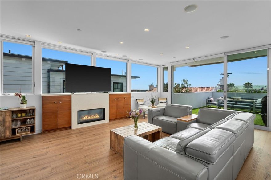 Stylish and sun-filled Hermosa Beach home just three blocks from the sand, with stunning ocean views stretching from Malibu to Catalina. The open layout connects a modern kitchen with a large island to the living room and a spacious deck—ideal for sunset dinners, casual hangouts, or entertaining friends. Inside, you’ll find warm wood floors, a cozy fireplace, and a built-in Sonos system throughout. Solar panels keep electric bills low, while central A/C keeps things cool. The 2-car garage includes a 220V outlet for EV charging, plus there’s room for two more cars in the driveway. Just far enough from Pier Ave for peace and quiet, but close enough to walk to top-rated restaurants, shops, and the iconic Comedy & Magic Club. All this, in one of the best school districts in the state.