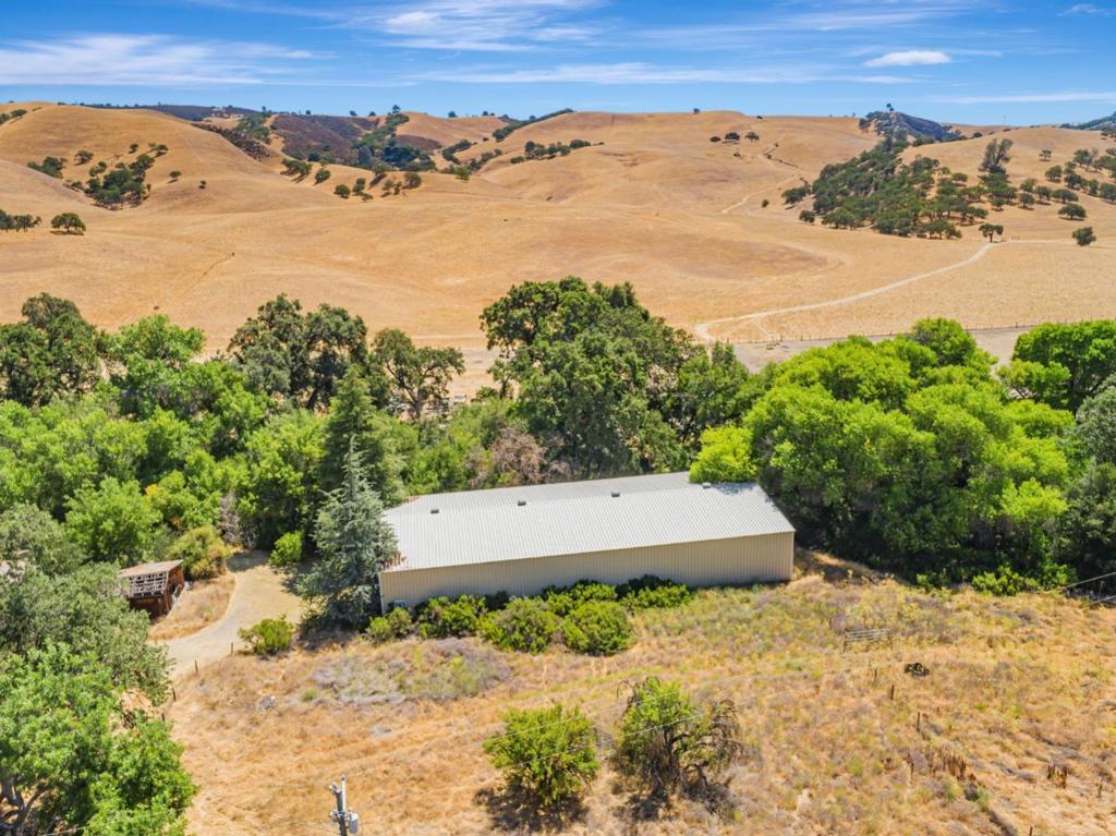 Nestled in the heart of Paicines, this property represents the very essence of San Benito County. Located just 25 minutes south of Hollister, this 7.2 acre parcel is a blank canvas for your rural dreams. Whether you're seeking a serene private getaway, an agriculturally zoned investment, or a taste of country living, this property offers the ideal foundation. Seasonal stream, well, septic, propane - conveniently located near Airline Highway but set back just far enough for privacy. The GIANT 60 x 120 metal building on site is currently being used as an indoor arena with a few stalls and a tack room. This property has two access driveways off of Airline Highway. Professional dog kennels on site. House permit unknown - due to the poor condition of the home, this property will not qualify for conventional financing. Cash, land loan and private money buyers are welcome. Enjoy your own cherry, plum, and almond trees. Pinnacles National Park is nearby, offering convenient access to its renowned hiking trails, scenic views, and outdoor recreational opportunities.