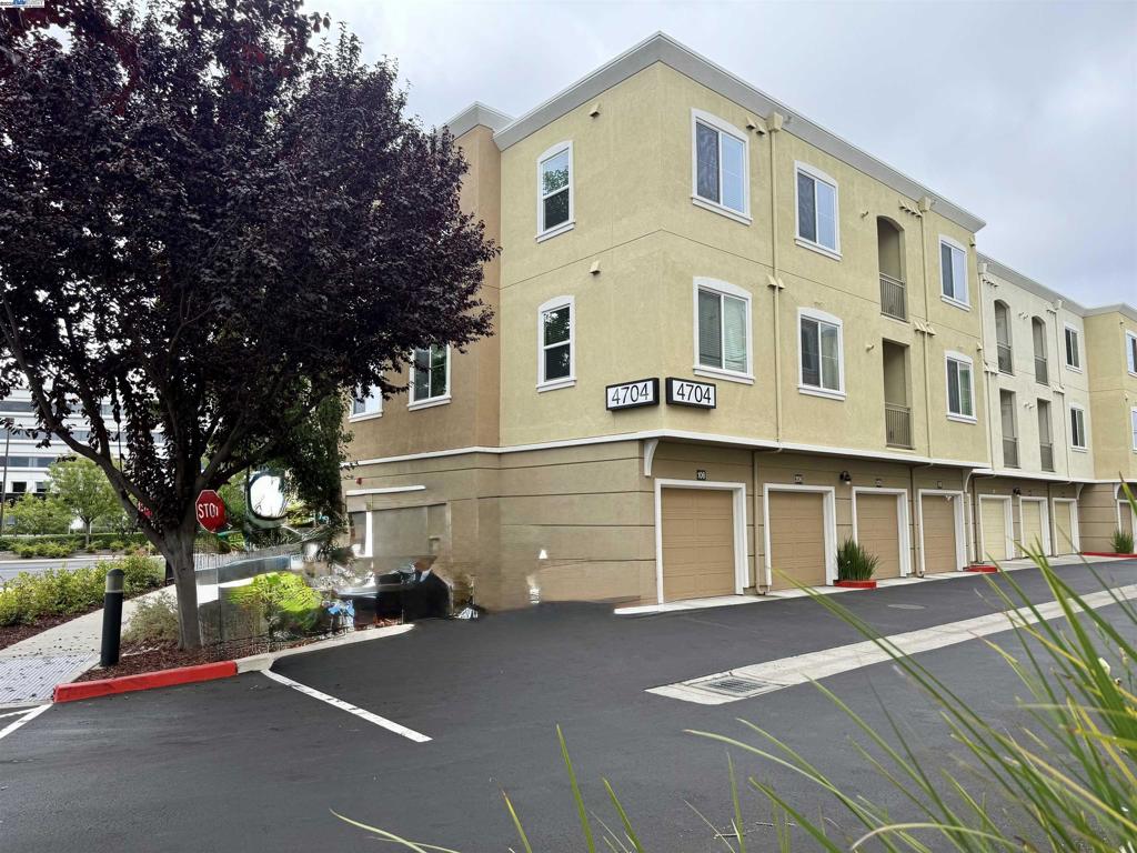 Newer construction with an open floorplan, second floor views and walking distance to award winning schools and the thriving 'City Center'. The complex is well cared for with beautiful flowering plants and tree lined walkways, playground and access to the Iron Horse Trail. Conveniently located for EZ freeway access and upscale amenities. Neutral decor, granite countertops, tile and wood-like flooring throughout (no carpet in the condo). Extra deep tandem, 2 car attached garage. Second floor end unit offers privacy and is conveniently located next to guest parking and access to Norris Canyon Road. Turn Key - move in ready!