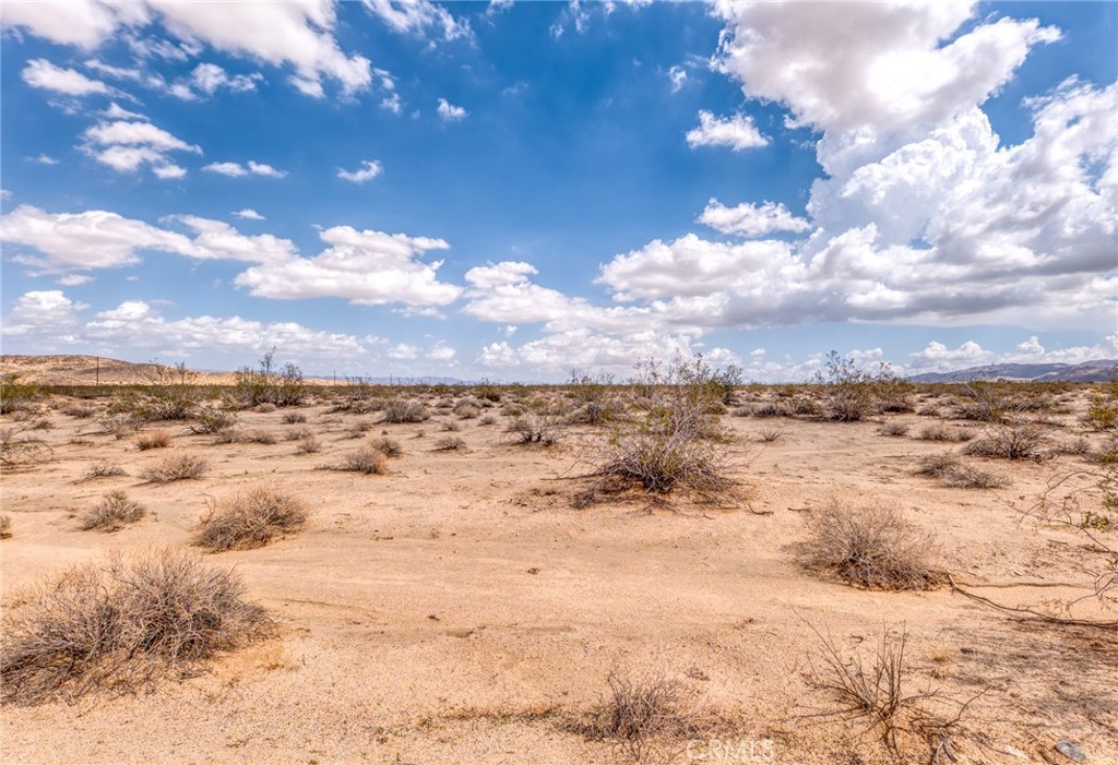 Discover 10 acres of flat, buildable land on the western edge of Twentynine Palms, just minutes from the entrance to Joshua Tree. This expansive lot offers panoramic 360-degree views of the desert mountains and open skies, making it an ideal canvas for development or long-term investment. Conveniently located off a dirt road not far from the highway, the property balances easy access with privacy and seclusion.
The surrounding region has seen strong growth and increasing interest from both tourists and investors, thanks to its proximity to Joshua Tree National Park. Whether you envision building a private retreat, subdividing for multiple uses, or holding as a land bank opportunity, this property offers flexibility and potential in one of California’s most sought-after desert communities.