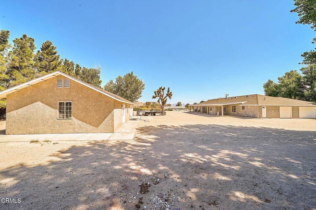 Welcome to 10298 Custer Ave, a brand-new home completed in 2024, located on a desirable, paved road in the growing rural community of Lucerne Valley. Situated on a generous 2.15-acre lot, this property offers space, comfort, and stunning desert views. The home features 5 spacious bedrooms and 3 full bathrooms, with a functional floor plan that includes a formal living room and dining room, wide handicap-accessible hallways, and three separate patios--perfect for family gatherings or relaxing evenings. Enjoy year-round comfort with central air conditioning and heating, while the home is also equipped with natural gas and a private well for efficient utility use. The workshop includes a half bath and a garage, offering great potential to be converted into an ADU for extra income or multigenerational living. Mature trees provide plenty of shade, complementing the amazing views that surround this peaceful retreat. this property offers the space and setting to do so. It's a wonderful opportunity for those looking to enjoy the freedom of country life without giving up modern comforts.