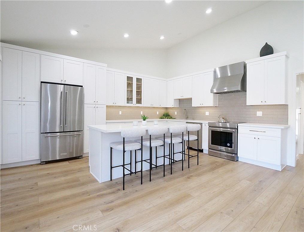Don’t miss this incredible opportunity to lease a beautifully renovated, fully furnished 2-bedroom, 2-bathroom top-floor condo in the highly sought-after Brookside Village—a lush, resort-style community in a prime location. This light-filled unit is tucked away in a quiet area of the complex and showcases an open-concept layout with vaulted ceilings and modern finishes throughout. The stylish kitchen features Quartz countertops, a large center island with breakfast bar seating, stainless steel appliances, and generous cabinet space. The spacious living room opens to a private balcony overlooking serene greenery—perfect for relaxing or enjoying your morning coffee. Both bedrooms are generously sized, including a luxurious primary suite with its own spa-like bathroom. Additional highlights include durable vinyl plank flooring, recessed lighting, in-unit washer and dryer, and two dedicated parking spaces. Brookside Village offers beautifully maintained grounds with sparkling pools, tranquil water features, tennis courts, a fitness center, and a clubhouse. Conveniently located near parks, top-rated schools, shopping, dining, and just minutes from the beach, this home offers the perfect blend of comfort and convenience.