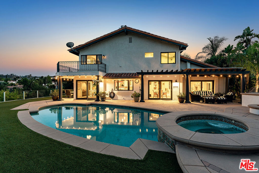 Welcome to one of the most coveted pockets of Calabasas, where homes rarely come available. This pool home boasts massive views and is situated at the end of a cul de sac on one of the best streets in Classic Calabasas. An inviting 4-bedroom, 5-bathroom, this residence spans approx. 3,880 sq. ft. on a 9,056 sq. ft. lot and offers a thoughtful floor plan designed for both everyday comfort and entertaining. Step inside through double doors to soaring ceilings, light-filled spaces and designer touches. The main level features a spacious living room with beamed ceilings, a cozy fireplace, and views of the pool and Calabasas surrounds. The seamless flow into the open-concept eat-in kitchen and dining area makes this home perfect for entertaining. The kitchen is equipped with a granite-topped island, Dacor double ovens and 6-burner range, a walk-in pantry, and built-in workspace - perfect for both chefs and busy households. The attached dining area is flanked by glass showing off the incredible views. The welcoming family room with fireplace, plantation shutters, and spacious bar is the perfect place to retire after dinner. Just down the hall is a large en-suite guest bedroom with access to the backyard. Beyond the laundry room, one of the garage bays was converted into a mud/craft room. There is an additional office/guest room with desks, Murphy bed and ample bookcases perfect for a large home office. Upstairs, the primary suite offers a private retreat with fireplace, a balcony with panoramic views and dual walk-in closets. The luxurious primary bath features a dual vanity, soaking tub and oversize shower. Each of the two upstairs secondary bedrooms has an en-suite bath, with thoughtful built-ins and hillside or backyard views. The backyard is an entertainer's dream with a pool, spa, built-in BBQ, fire pit, and grassy areas for play or relaxation - all set against a backdrop of sweeping views. With two covered loggias for dining and relaxing, this home has all of the bases covered. Set in the heart of Calabasas, residents enjoy access to award-winning Blue Ribbon schools, upscale shopping and dining at The Commons, and world-class hiking trails. With close proximity to the scenic Malibu coastline and the natural beauty of the Santa Monica Mountains, this home offers the best of both convenience and California living. Warm, welcoming, and filled with potential, 23306 Park Hacienda is a rare opportunity to own in one of Calabasas's most desirable neighborhoods.