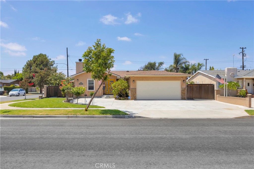 Charming Anaheim Home for Lease – Spacious Corner Lot! Discover a wonderful opportunity to lease this beautifully upgraded single-family home, ideally situated on a spacious corner lot in an established Anaheim neighborhood. This inviting residence features 3 generously sized bedrooms and 2.5 bathrooms, designed with comfort and functionality in mind. The open family room boasts cathedral ceilings, a cozy fireplace, and a ceiling fan, creating the perfect setting for relaxation and gatherings. The modern kitchen is equipped with stainless steel appliances, bar seating, and plenty of cabinet space, making it a chef’s delight. Flooring throughout the home includes a stylish mix of tile, wood, and carpet. The primary suite offers a retreat-like feel with two closets (including a large walk-in), and an ensuite bathroom featuring a soaking tub and tiled shower. Additional highlights include mirrored closet doors, a tankless water heater, and newer AC for year-round comfort. Outdoors, you’ll find a wonderful backyard with a grassy play area and covered gazebo, perfect for entertaining or relaxing. The property also offers ample parking, including RV parking with hookups, plus an optional security system with cameras for peace of mind. This home is truly move-in ready and offers a rare blend of upgrades, space, and convenience in a desirable neighborhood.