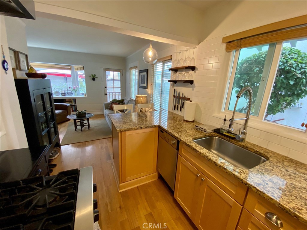 This sweet property oozes vintage storybook-charm. Located on the North side of a 1920's built duplex with modern touches, you have: Unfurnished 1 bedroom PLUS a loft space for an office or den, 2 bathrooms, stainless steel kitchen appliances, granite countertops, hardwood floors, all-in-one-washer/dryer, brand-new window wood blinds throughout, tankless water heater, a sweet brick patio with a storage shed, and is located just a few short blocks to the beach. Location is key. Beach living is coming your way.