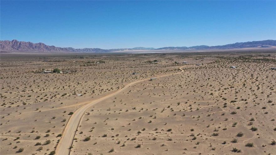 This 5-acre parcel in Wonder Valley offers open desert space with county-maintained dirt road access and expansive views across the high desert. Sitting at approximately 1,315 feet in elevation, the level terrain and Rural Living (RL-5) zoning allow for a single-family home, mobile or manufactured home, or limited camping, giving you flexibility to use the land at your own pace.
Located east of Twentynine Palms and bordered by vast stretches of public land, the property provides a quiet setting while remaining within 20–25 minutes of schools, groceries, fuel, and local services. Joshua Tree National Park is a short drive away, making this an appealing option for buyers seeking space, access, and a practical location in San Bernardino County’s high desert.