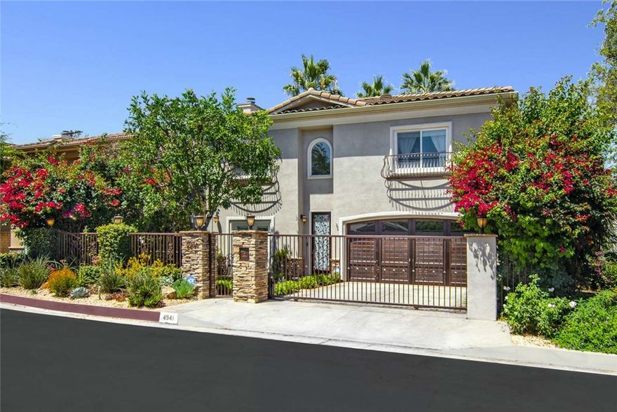 This stunning two-story gated home combines style, functionality and security, with stacked stone accents and meticulously manicured landscaping. Located in the Encino flats area where newly constructed homes are selling at $3.5mil and more, this home offers comfortable convenient luxury living, while enjoying continued appreciation. Minutes to the Westside, and blocks from Ventura Boulevard, offering endless dining, shopping, medical and business services.

Inside this home, French oak floors grace the entire first level, with a spacious living room with gas fireplace, formal dining room with a coffered ceiling, built-in cabinetry, a dry bar with wine fridge, and crystal chandelier. Two sets of dual French doors make indoor-outdoor entertaining flow. Fully remodeled chef’s kitchen includes custom cabinetry, Carrara marble seamless countertops, Sub-Zero glass-front fridge, Wolf six-burner range with pot filler, double ovens, built-in microwave, walk-in pantry, and a breakfast nook, all open to the adjacent den with second fireplace and French doors to the outdoor BBQ with covered dining area.



Upstairs are four spacious bedrooms, three full baths, and laundry. The luxurious primary suite boasts dual custom walk-in closets, a generous travertine full bath with large jetted tub, separate shower, and dual vanities.



The beautifully landscaped backyard features two patios with retractable awnings, a lush grassy area, a built-in hot tub, a custom BBQ station, and charming string lighting—perfect for outdoor entertaining. Additional highlights include a finished garage with an epoxy floor and built-in cabinetry. This smart home is also equipped with Ring security cameras; a water-saving automated irrigation system; a tankless water heater for endless hot water, dual-zone HVAC with energy-efficient Nest thermostats; mobile-app controlled outdoor lighting, garage door and front door; and a premium Bose surround sound system.