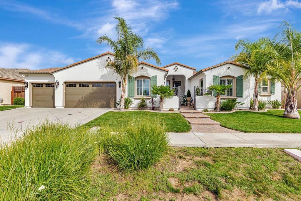 Welcome to your dream home. A stunning single-story retreat featuring 4 spacious bedrooms with walk-in closets, 3.5 luxurious baths, and a fully finished, insulated 3-car garage, all on a beautifully landscaped 12,678 Sq. Ft. lot with no HOA fees. With 3,264 Sq. Ft. of elegant living space, this home offers soaring ceilings, central heating and A/C and ceiling fans. The chefs kitchen is equipped with a double range oven, 36" five-burner stovetop, in-cabinet microwave, expansive counters, and a large walk-in pantry. The grand primary suite features two oversized walk-in closets, a spa-like bath, and private sliding glass door access to the backyard. Enjoy seamless indoor-outdoor living with a covered lanai, built-in gas line, tropical landscaping, and a backyard with both cemented and grassed areas surrounded by resort-style palm trees. A custom courtyard entrance welcomes you with wrought iron gates, decorative pavers, and a Wi-Fi-controlled fountain. Smart home upgrades include WeMo-controlled landscape lighting, Wi-Fi-enabled sprinklers, a water softener, security cameras, and a hardwired alarm system for peace of mind. This home is the perfect blend of luxury, comfort, and modern convenience.