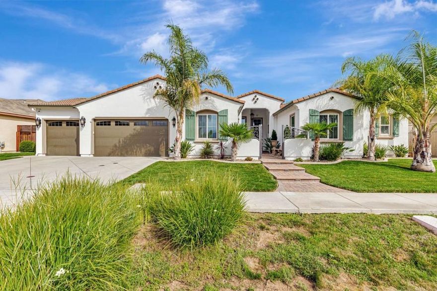 Welcome to your dream home. A stunning single-story retreat featuring 4 spacious bedrooms with walk-in closets, 3.5 luxurious baths, and a fully finished, insulated 3-car garage, all on a beautifully landscaped 12,678 Sq. Ft. lot with no HOA fees. With 3,264 Sq. Ft. of elegant living space, this home offers soaring ceilings, central heating and A/C and ceiling fans. The chefs kitchen is equipped with a double range oven, 36" five-burner stovetop, in-cabinet microwave, expansive counters, and a large walk-in pantry. The grand primary suite features two oversized walk-in closets, a spa-like bath, and private sliding glass door access to the backyard. Enjoy seamless indoor-outdoor living with a covered lanai, built-in gas line, tropical landscaping, and a backyard with both cemented and grassed areas surrounded by resort-style palm trees. A custom courtyard entrance welcomes you with wrought iron gates, decorative pavers, and a Wi-Fi-controlled fountain. Smart home upgrades include WeMo-controlled landscape lighting, Wi-Fi-enabled sprinklers, a water softener, security cameras, and a hardwired alarm system for peace of mind. This home is the perfect blend of luxury, comfort, and modern convenience.