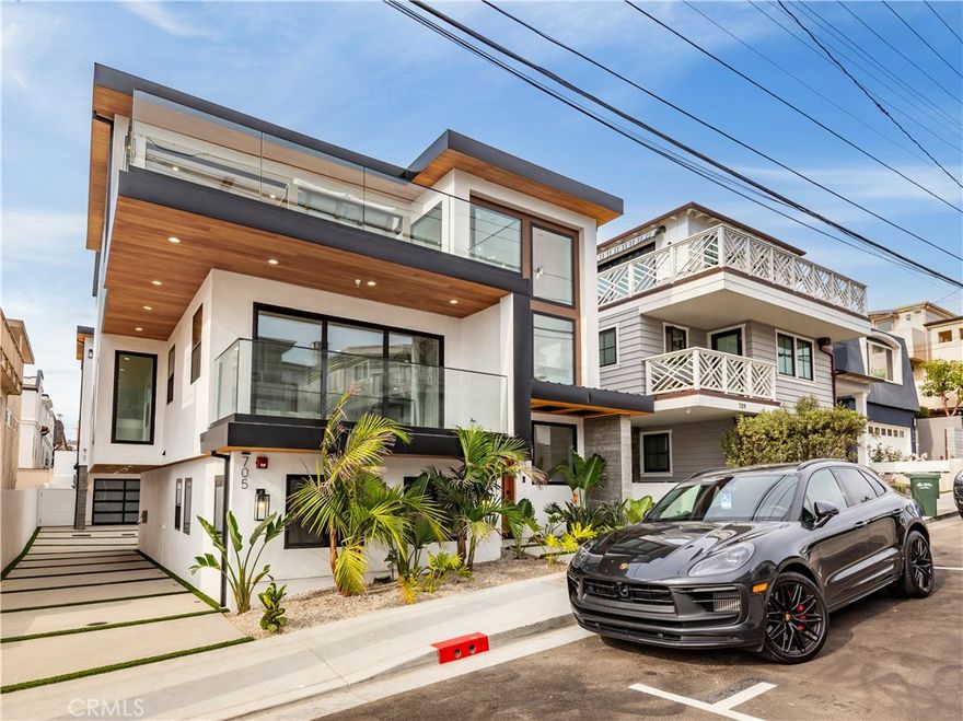 This 4-bedroom, 4.5-bathroom coastal modern townhome embodies luxury, style, and sustainability. Meticulously designed, this 2,831 square foot masterpiece features a gourmet kitchen equipped with top-of-the-line Sub-Zero and Wolf appliances, complemented by a spacious 10-foot marble island, white rift oak cabinetry, and custom underlit lighting that adds a warm, elegant touch. The open-concept living spaces are adorned with solid oak wide-plank flooring, high-end Andersen windows and oversized sliders. The primary suite is a private retreat all its own, complete with a spa-inspired bath featuring a freestanding soaking tub, glass-enclosed walk-in shower, dual vanities, and direct access to a serene outdoor deck. Every detail, from the underlit cabinetry and stair lighting to the power-saving fixtures and sustainable wood accents, speaks to quality craftsmanship and thoughtful design. As day turns to night, architectural outdoor lighting along the home’s exterior and pathways sets the tone for relaxed luxury. And above it all, the rooftop deck with gas and water hookups offers panoramic views of the Queen’s Necklace, ideal for entertaining, relaxing, or simply taking in the beauty of the South Bay. With a wine cellar, three-stop elevator, and multizone smart climate control, this home offers a lifestyle as effortless as it is exceptional. Every day is truly a reminder: When you buy here, you're buying a lifestyle!