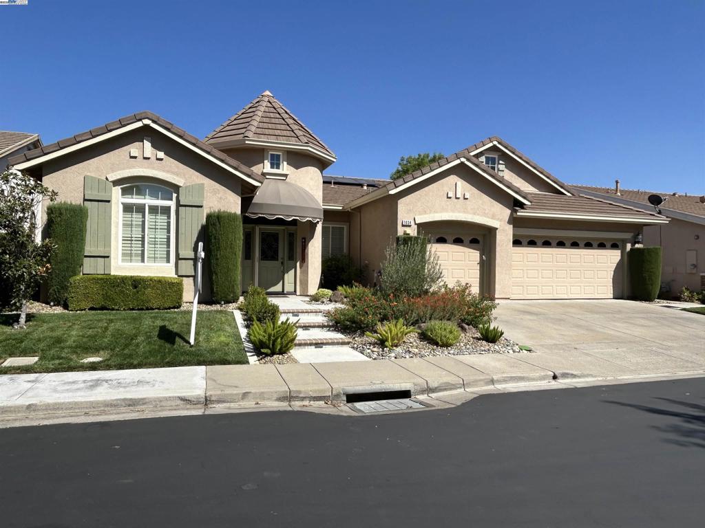 Largest model in Summerset Community Formal Living & Dining Rooms, Laminate flooring Throughout only Bedrooms are Carpeted. Plantation Shutters Also throughout. Kitchen features include Granite Island & Counters Two Pantry's GE & LG stainless Steel Appliances, Adjoining Breakfast nook, Family room W/Gas Fireplace, Spacious Master Suite W/Sitting Area & Gas Fireplace, Big Walk-In Closet Master Bath Has Dual Vanity's, Separate Shower & Jetted Tub. Secondary Bedroom Has its own In-suite bath. Three Car Garage W/Epoxy Floors, Work Bench & pull down Attic Storage. Low maintenance rear yard W/covered Patio & Perimeter Wrought-Iron Fencing Owned Solar W/back-up storage. All this & more Await you in this active Adult Community.