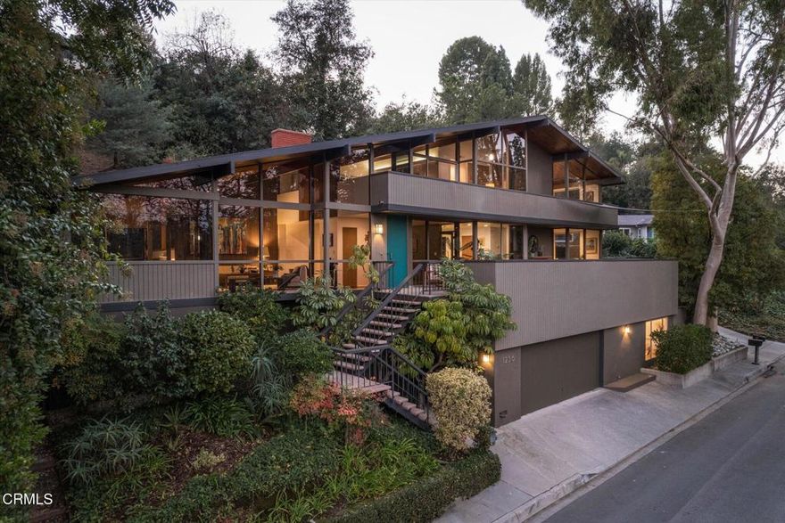 Set behind gates within an exclusive lakeside community, this striking post-and-beam mid-century modern residence offers rare privacy, serenity, and access to a private lake with a pool, park, and recreation area.Featuring 4 bedrooms and 4.5 bathrooms, the home is defined by its vaulted ceilings, floor-to-ceiling windows, and organic wood cladding that blend timeless architectural design with the surrounding natural landscape. The interiors invite light and views from every angle, creating a seamless connection between indoors and out.A newly remodeled kitchen anchors the main living space--perfectly designed for both daily living and entertaining. The expansive primary suite features an updated bathroom and direct access to the outdoors, while three additional en suite bedrooms each offer comfort and privacy for family or guests.The wrap-around patio overlooks tranquil lake views, ideal for morning coffee, sunset gatherings, or quiet reflection.Located in one of Pasadena's most sought-after gated enclaves, this exceptional home offers the feeling of being immersed in nature--yet just moments from the city's vibrant cultural and dining destinations. A rare opportunity to live in a setting that is private, secure and profoundly connected to its natural surroundings.