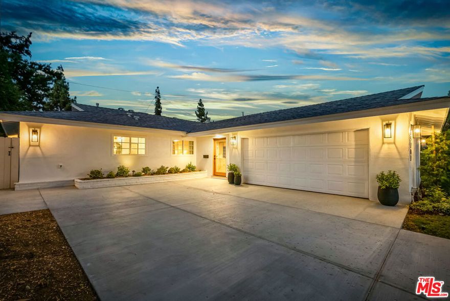 Welcome to prime Granada Hills! This reimagined 3BR + 2BA, approximately 1,800 sq ft, California Ranch has been thoughtfully transformed into a modern showpiece, blending timeless charm with today's most sought-after upgrades. Inside, the open-concept design creates effortless flow for both entertaining and everyday living. At the heart of the home, the chef's kitchen showcases sleek porcelain counters, a waterfall island, a full-height backsplash, and premium stainless-steel appliances, including Forno professional range, dishwasher, and French door refrigerator with dual freezer drawers. Wide plank engineered hardwood floors, recessed lighting, and a modern fireplace to bring warmth and style throughout. The highlight is a true primary suite that feels like a retreat, complete with direct backyard access, two closets (including a walk-in), and a spa-inspired ensuite bathroom. Outdoors, a spacious yard with citrus trees sets the stage for gatherings, play, or quiet evenings under the stars. Additional upgrades include a newer roof, electrical panel and water heater, fresh paint inside/out, recessed lighting, smooth ceilings, refreshed entry, and a beautifully finished garage (could be a rec room, office, gym, or even bedroom) that adds versatile living space. All of this in a prime location, just minutes from award-winning Granada Hills Charter schools, Knollwood Golf Course, Aliso Canyon, O'Melveny Park, and shopping at The Vineyards at Porter Ranch. Conveniently located near the 5, 118, and 405 freeways, you'll enjoy quick access to Burbank, Downtown LA, and the Westside. Every detail of this home has been carefully curated, making it a true turnkey property ready to begin its next chapter. Interior design by - S and S Design.