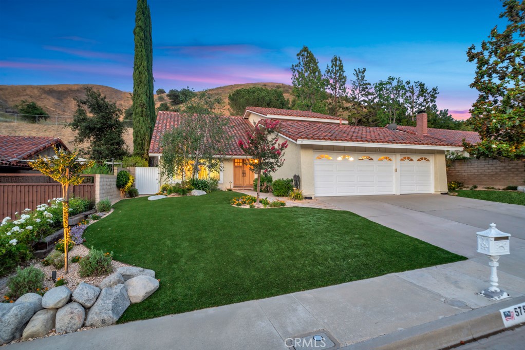 Impressive Expanded Fountainwood Home on Over Half an Acre lot. This beautiful residence offers an exceptional blend of space, function, and luxury. With 2,928 sq ft of living space, this stunning home features 4 spacious bedrooms plus a dedicated office, 3 bathrooms, and sits on a huge lot over ½ acre—perfect for both entertaining and everyday living. Step through double entry doors into a dramatic vaulted foyer, leading to a formal living and dining room, and a warm, inviting den with fireplace and built-in cabinetry. The downstairs bedroom and adjacent office offer a flexible layout, ideal for guests or an in-law suite. You’ll also find a ¾ bath and a convenient indoor laundry room. The upgraded kitchen showcases quartz countertops, a designer backsplash, stainless steel appliances, a walk-in pantry, and expansive views of the backyard retreat. Upstairs, the primary suite impresses with a walk-in closet, spacious bathroom featuring a soaking tub, separate shower, dual sink vanity, and an extra closet for ample storage. Two more generously sized bedrooms and a full bathroom complete the upper level. Step outside to your private paradise with a pool and spa with built-in slide, sports court, ground-level trampoline, built-in BBQ, retractable awning, and a cozy built-in firepit. Pool features are conveniently controlled by an indoor panel or remote. A 3-car garage and impressive curb appeal complete the package. Located within the highly-rated Las Virgenes School District and just minutes from scenic hiking and biking trails and beautiful local parks, this is the perfect home for those seeking space, lifestyle, and comfort.