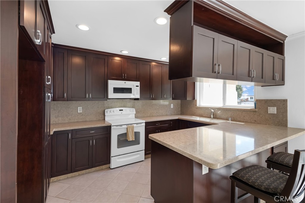 Located at the end of the cul-de-sac at 1200 Opal Street, this wonderful townhome in the Peppertree Village complex is available for the first time in 31 years. Beautifully maintained 2 bedroom / 2 1/2 bath residence with 1,450 square feet of living space. Large entry level patio off the living room plus 3 additional balconies off the kitchen and bedroom areas. Newer sliding glass doors and window. Remodeled kitchen with stone counters and a breakfast bar. Nice sitting area off the kitchen. Double door entry to the spacious living room with fireplace. Large dining area and laundry room off the kitchen. Recently painted with new carpet in both bedrooms. Large closets, multiple storage areas and side by side parking spaces (33 & 34). Peppertree Village is a controlled access building with community pool, spa and streams running through the open space. Hurry, this unit is priced to sell and will not last long.