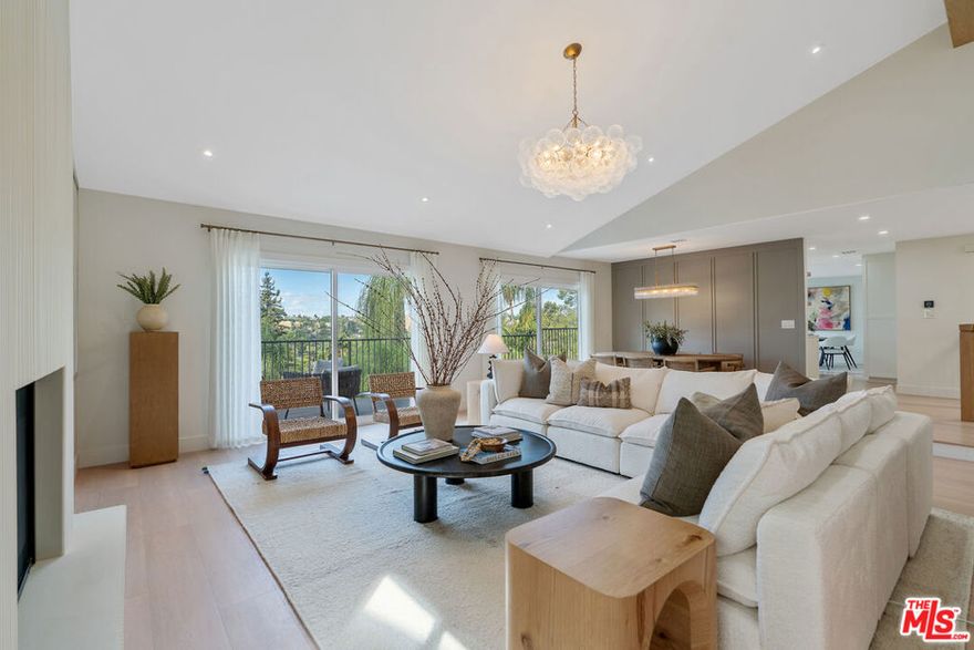 Discover the timeless beautify of 4825 Galendo Drive - A fully Remodeled Woodland Hills Estate with Sweeping Views. Located South of the Boulevard in one of Woodland Hills' most desirable neighborhoods, this beautifully remodeled residence offers over 4,000 sq. ft. of living space with soaring ceilings and panoramic views of the mountains and treetops from nearly every room. 4825 Galendo Drive has been fully reimagined as a brand-new home offering a one of a kind living experience with a curated interior design. Every detail of this single story 6 bedroom 4 bathroom residence has been thoughtfully upgraded inside and out - including dual primary suites with expansive walk-in closets and spa-inspired baths. The impressive vaulted-ceiling family room is centered by a custom fluted fireplace and includes a built-in bar area, while the dining room captures stunning sunset views. A chef's kitchen with a large center island, premium appliances including a Thermador range and a charming breakfast room with custom built-ins completes the main living area. A sweeping balcony extends off the main level, offering serene vistas and seamless indoor-outdoor living. The lower level provides a full guest/entertaining suite complete with its own kitchen, bedroom, and full bath, ideal for visitors, extended guests, or multi-generational living. The backyard is designed for resort-style entertaining, highlighted by a covered patio, sparkling pool with waterslide, and cascading spa set against a backdrop of tranquil canyon scenery. This home combines elegance, versatility, and breathtaking views in a prime Woodland Hills location.