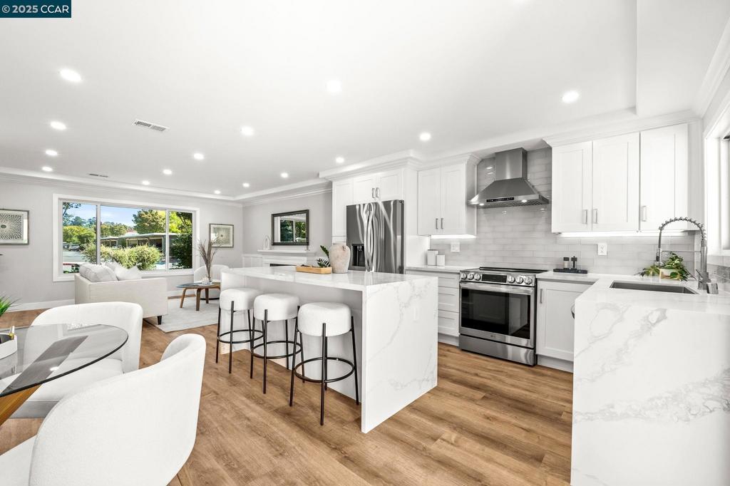 One of One. Beautifully remodeled by Rossmoor Renovations, this rarely available, reconfigured 2 bedroom / 2 bath single-row, level-in, end-unit San Franciscan offers partial, tree-framed views of Mount Diablo with ample guest parking right in front of the home. The front patio and private courtyard have been upgraded with new tile, creating seamless indoor-outdoor living and a perfect space to relax or entertain. Inside, the elegant open floor plan seamlessly connects the kitchen, dining, and living areas. The designer kitchen features a quartz waterfall island, custom cabinetry, a full suite of stainless steel appliances, and an in-unit washer/dryer. Tray ceilings and recessed lighting enhance the spacious living room with fireplace and custom wainscoting. The bathrooms are spa-inspired with frameless glass showers, designer tile, seating, and elegant vanities. All windows are double-pane Andersen windows, and every finish in this home was carefully selected with no expense spared. Come experience this luxury Rossmoor retreat—a rare opportunity to own a truly unique San Franciscan.