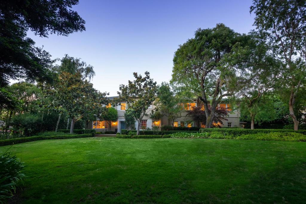 Regally situated in the finest Country Club location of lower north Hillsborough, this timeless gated estate offers grand-scale space in an enchanting setting. The .71-acre level lot is highlighted by a long, private driveway, sweeping level lawns, charming fountains, & a brick patio with pergola. Features include elegant public rooms with French doors that open to the rear grounds, a chefs kitchen with endless counter & cabinet space, a huge family room with boxed-beam ceiling, fireplace, & direct yard access, as well as a wood-paneled library with hidden bar, a powder room, & an office with half bath. Upstairs offers four sizeable bedroom suites, including the master suite with a huge sitting room with fireplace, & a stunning bathroom with separate vanities & dressing areas, multiple closets, & a laundry room. Outside, the park-like grounds offer numerous venues for playing, entertaining, & simple relaxation, & is a short distance from downtown Burlingame Avenue, & top-rated schools
