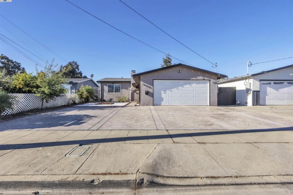Welcome to 36621 Beutke Drive, Newark, CA 94560 Well-maintained and thoughtfully upgraded home located in a convenient Newark neighborhood. The garage has been converted into two rooms with one bathroom, offering versatile use as guest rooms, home office, or extended living space. Laundry area is located in the garage.  Enjoy outdoor living with a built-in outdoor kitchen with sink, solar-powered string lighting, and concrete pavement surrounding the home for easy upkeep. The spacious driveway provides parking for 5–6 vehicles.  This home is equipped with 17 solar panels and a backup battery system, tankless water heater (9 gal/min), centralized air conditioning, new sewage piping and cleanout in front, water softener, and alkaline water system.  Interior highlights include entertainment wall panels in the living room, recessed lighting in main areas, custom shelving in the kitchen, and a closet/wardrobe in the second bedroom. Additional upgrades include roof gutters at the front entrance and efficient systems throughout for long-term comfort and savings.  Conveniently located near schools, shopping, parks, and easy access to major freeways—ideal for commuters to Silicon Valley and the East Bay.