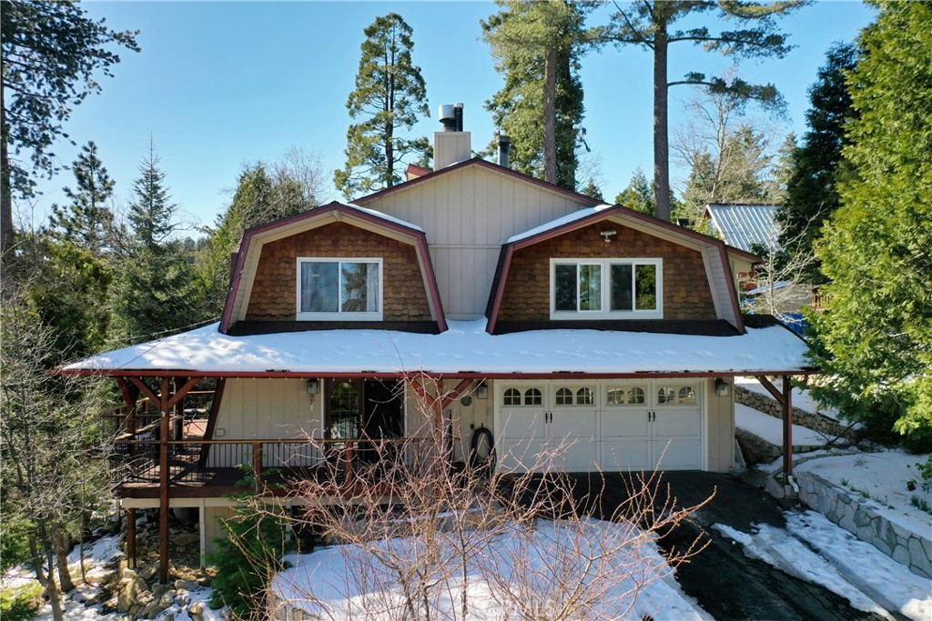 Charming Gambrel architectural home & bonus Gambrel addition has 270-degree view of mountain ridge. Sprawling property w/oversized French doors opens into the living/dining/kitchen Open Floor Plan. Picture window, granite counters stainless steel appliances, are all framed under beamed ceilings. Rich hardwood floors, large custom stone (corner) fireplace and large bathroom with marble tile complete the main level.
A “floating staircase” leads up to 3 bedrooms including an extra-large primary suite with moonscape windows at the top of the cathedral ceilings throughout. This unique space is bright and has a wood-burning hearth fireplace on one end and a small platform jacuzzi spa on the other.
The terraced corner lot has several concrete landings for entertaining, full wrap around deck with decorative iron railings & 6-seater jacuzzi in the landscaped back yard among fruit trees and stone-lined floral beds. Home is located on quiet corner lot w/2-car garage and long driveway lined with river rock retaining wall. Attached to the garage is a large bonus room additional w/400 SQ FT with water and gas, windows, custom shelves/cabinetry as potential ADU. Fireplaces are simulated.
