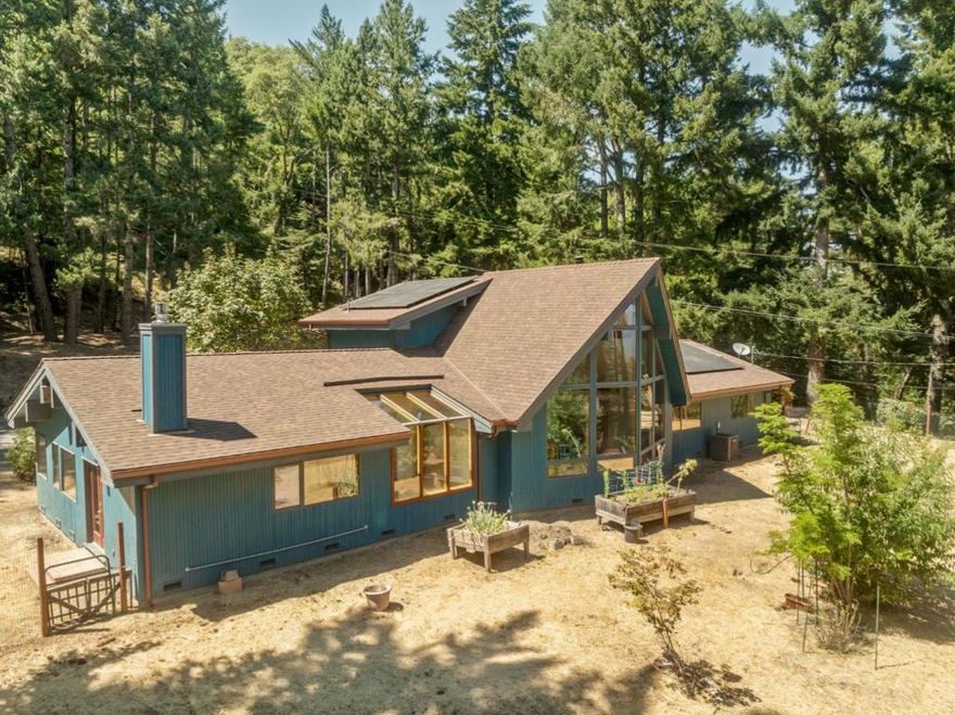 Large Tahoe-Inspired Home on 4 Acres, with Mountain and Valley Views, tucked into a desirable enclave in the Los Gatos Hills with tree-lined views out to Mount Ummanhum and across Silicon Valley, amidst gently sloped front, side and rear yard areas with fruit trees and ample room for a small arena, a barn, a sport court, a pool plus multiple sites for outbuildings, tents or whatever! Start each day in the grand primary suite with its walk-in closet and oversized tub with jets for a stay-at-home spa experience. The kitchen is a culinary enthusiast's delight, equipped with twin granite peninsulas, a gas cook top, a combo oven with convection, and a warming drawer. Treat your guests to atrium dining under the sun by day and the stars by night. Soaring open beam ceilings and walls of glass impart a spacious feel throughout, made warm with rich wood accents. Enjoy the wood stove and fireplace, plus brand new Energy Star HVAC, backed by solar power and double pane windows to maximize your comfort year round while keeping your utility bills at a minimum. The separate family room with cathedral windows is the perfect vantage point to enjoy the view, or you can ascend the open staircase up to the giant loft area for recreation and entertainment. This is the one you've been waiting for!