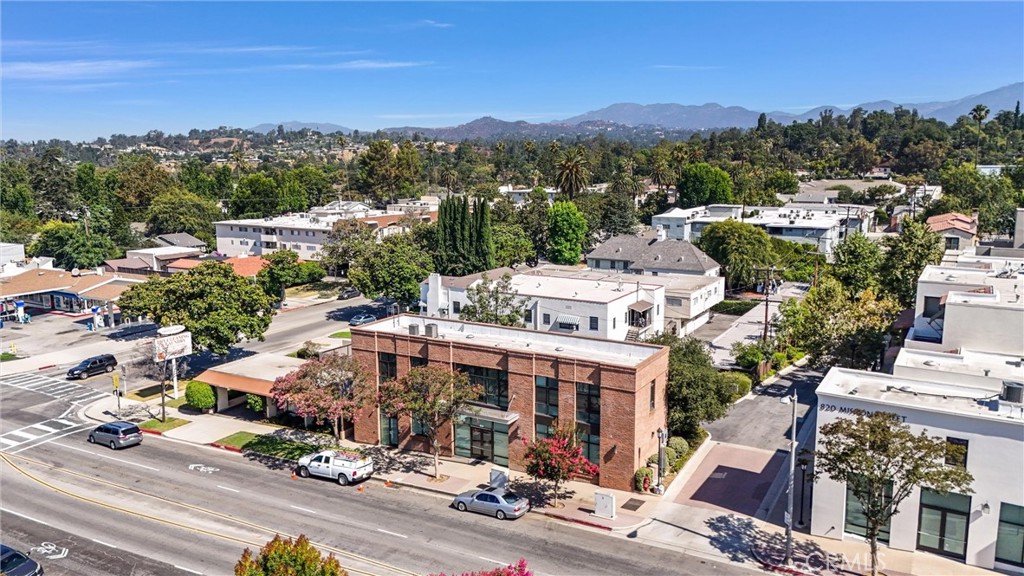 This corner-unit sits in a sought-after mixed-use community in the heart of South Pasadena. It has everything on your list: High-end finishes, private outdoor space, an attached garage and bonus space.
On the street level, you’ll find an entryway with soaring ceilings that’s filled with natural light. This level also offers a laundry area and a versatile den that could be a mudroom, craft area, office or home gym. The attached garage has vaulted ceilings and plenty of built-in storage.
The main level has an open layout lined by a wall of windows, which highlights the high ceilings & hardwood floors. The beautiful chef’s kitchen overlooks the dining/living areas and features sleek European cabinetry, stainless steel appliances, quartz countertops and a large island with seating for a crowd. Just off the living room, you’ll spend lots of time entertaining & relaxing on the massive balcony, complete with a retractable canopy.
Back inside, the isolated primary retreat boasts a spa-like ensuite with a walk-in closet, a modern double vanity, a free-standing soaker tub, a W/C and a frameless glass shower. The guest bedroom also has a custom closet and a beautiful private ensuite bathroom.
Unit 100 sits in a unique corner position within the Eight Twenty Mission community, as it’s not connected to another residential condo. You’ll be just steps from numerous shopping & dining options along Mission Street, as well as the weekly farmers market, public library, Metro Goldline station and more. Popular Orange Grove Park is located across the street, and this condo is zoned to top-ranked SPUSD. Make an appointment now to see this special South Pasadena residence!