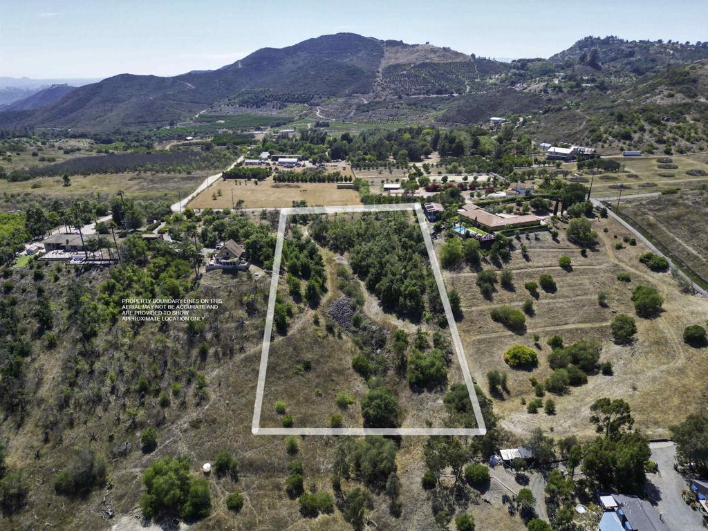 Rural and secluded 2.76-acre lot nestled in a peaceful valley with gentle to rolling terrain and a sizable flat portion for a home —ideal for the easy country living life. This build-ready parcel comes with a water meter, electric near by in the road and a 3-bedroom septic layout previously approved by the county. The pad area is surrounded by a professionally managed avocado grove, all on irrigation with a fertilizer tank and injector pod system. Owner has a set of house plans available. No CC&Rs—manufactured homes are welcome! Panoramic views of the mountains (including Palomar Mountain), gorgeous sunset views, cool ocean breeze, glimpse of the coastline along with quiet is the perfect set up for your future home—don't miss this opportunity to own a slice of country paradise.