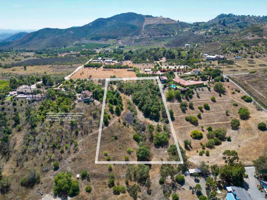 Rural and secluded 2.76-acre lot nestled in a peaceful valley with gentle to rolling terrain and a sizable flat portion for a home —ideal for the easy country living life. This build-ready parcel comes with a water meter, electric near by in the road and a 3-bedroom septic layout previously approved by the county. The pad area is surrounded by a professionally managed avocado grove, all on irrigation with a fertilizer tank and injector pod system. Owner has a set of house plans available. No CC&Rs—manufactured homes are welcome! Panoramic views of the mountains (including Palomar Mountain), gorgeous sunset views, cool ocean breeze, glimpse of the coastline along with quiet is the perfect set up for your future home—don't miss this opportunity to own a slice of country paradise.