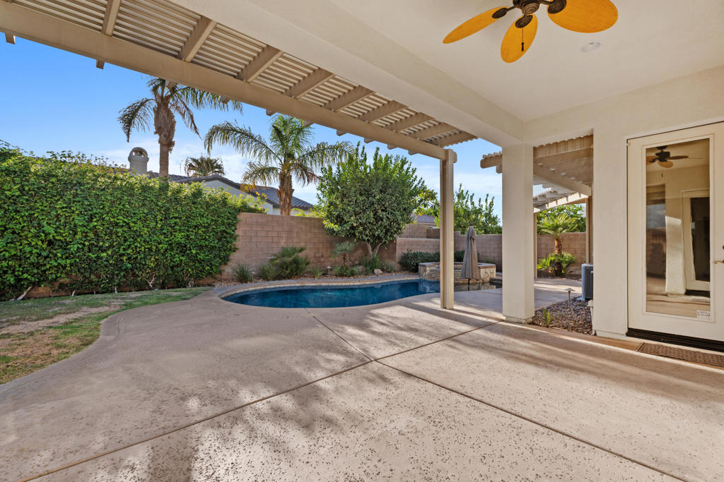Nestled in the sought after gated community of La Quinta Del Oro, this spacious property offers 5 bedrooms and 4 bathrooms including detached casita. The thoughtfully laid out floor plan provides versatility for visiting guests or space for a private home office. Designed with families in mind, it also offers an ideal option for those seeking the perfect vacation retreat or a lucrative long-term investment opportunity. With the 3rd car garage, you'll have ample storage including extra overhead racks. A misting system and extra pergola overhang ensures comfort even on hottest days while relaxing on the patio or enjoying the pebble tec salt water pool and spa. Interior amenities include custom tile in all bathrooms, granite slab countertops in kitchen, stainless steel appliances , plantation shutters throughout, and walk-in closets in all bedrooms to name a few. This superb location is right across from Indian Wells Tennis Garden, and within close proximity to Old Town La Quinta, music festivals, shopping, and dining.
