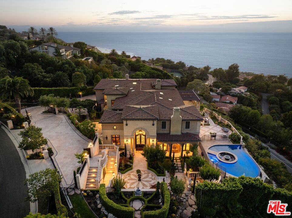 OVER $2M PRICE IMPROVEMENT! Set above the Pacific with uninterrupted views stretching to the horizon, this coastal estate is a masterpiece over seven years in the making. More than a home, it is a singular expression of craftsmanship, design, and intention. From the moment you enter, the grand scale is balanced by warmth and livability. Expansive entertaining rooms are designed for both hosting and everyday family life, blending timeless elegance with comfort. Custom chandeliers from Italy add a dramatic sense of opulence, while a breathtaking collection of hand-selected marble anchors the interiors. No two slabs are alike, and each was shaped and polished by artisans to form a visual rhythm that flows throughout the home. Outdoors, flat grassy lawns roll out like a private park, perfect for kids, pets, or weekend gatherings. One-of-a-kind design moments include a show-stopping firepit built directly into the pool, where flames rise from water in an unforgettable architectural flourish. Walls of glass frame panoramic ocean views, connecting indoor living with the raw beauty of nature. Multiple terraces, wide-open lawns, and sunset-facing vignettes make this property feel like a retreat. With privacy, soul, and unparalleled attention to detail, this estate is a celebration of coastal luxury reimagined for modern life.