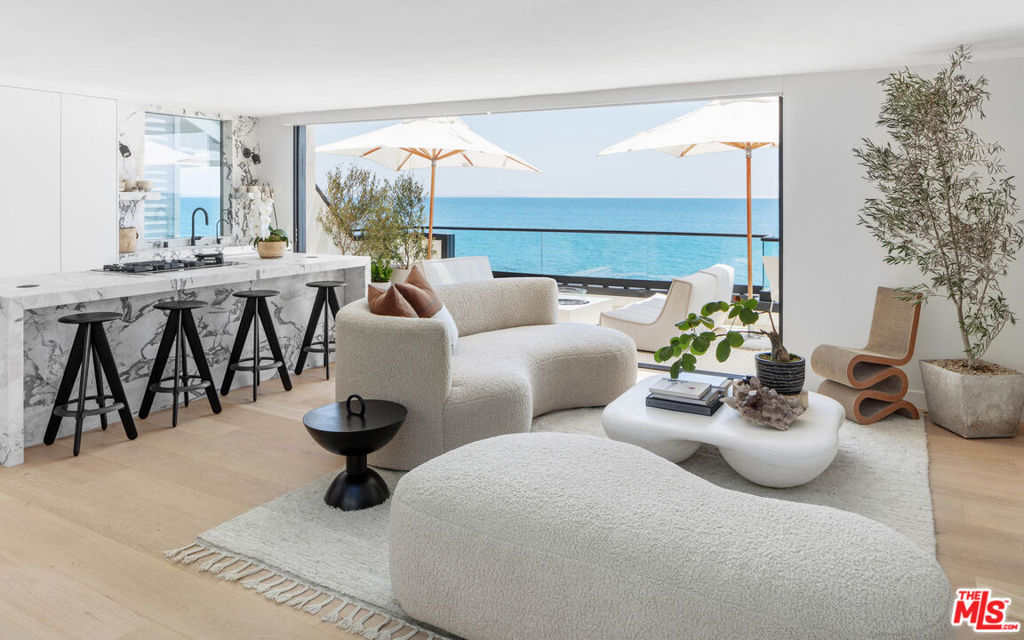 Exceptional architectural beach home, situated on approx. 53' of Las Flores beach with stunning panoramic ocean, island, coastline, and Queen's Necklace views. From the gourmet cook's kitchen with the latest Miele appliances & custom cabinetry to the sleek and elegant 3 bedrooms and 5 bathrooms, this magnificent renovated Malibu home is now ready for the most discriminating buyer. The open plan living & dining rooms feature high ceilings and multiple skylights, providing a bright & natural light with outside views of the mountains and multi-slide pocket glass doors that open onto an expansive deck, offering breathtaking ocean and city views. Perfect for indoor-outdoor entertainment. A mezzanine family room looks over the second level with a third bedroom and full bathroom. All bedrooms have views of the ocean.Other features include white oak floors throughout, covered two car garage and additional street parking. This move-in ready dream home is an incredible opportunity to live an iconic Malibu lifestyle and is only minutes away from central Malibu or Santa Monica.