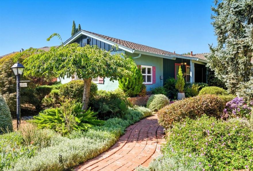 First time this family home has hit the market - this gem is much more than first meets the eye. It offers ~1,890 square feet of comfortable living space, featuring three bedrooms, two full bathrooms, a dining room and indoor laundry. But keep looking - there is a large bonus room with a separate entrance, an ideal office / home gym / craft or flex room. Detached 2-car-garage accessible from the back, with a huge workshop + flex space and additional full bathroom, with enough space and potential for an ADU conversion. The heart of the home is the kitchen with a breakfast table and plenty of storage, perfect for preparing meals and chatting with family or guests. Enjoy cozy evenings by the fireplace, updated flooring and interior paint done this year. Situated on a generous lot of over 8,250 square feet, this property is an enchanting garden with mature trees and beautiful landscape, inviting you outdoors with ample outdoor space for gardening, recreation, or relaxation. In one of the most charming neighborhoods in Gilroy, make an appointment to see this house today!