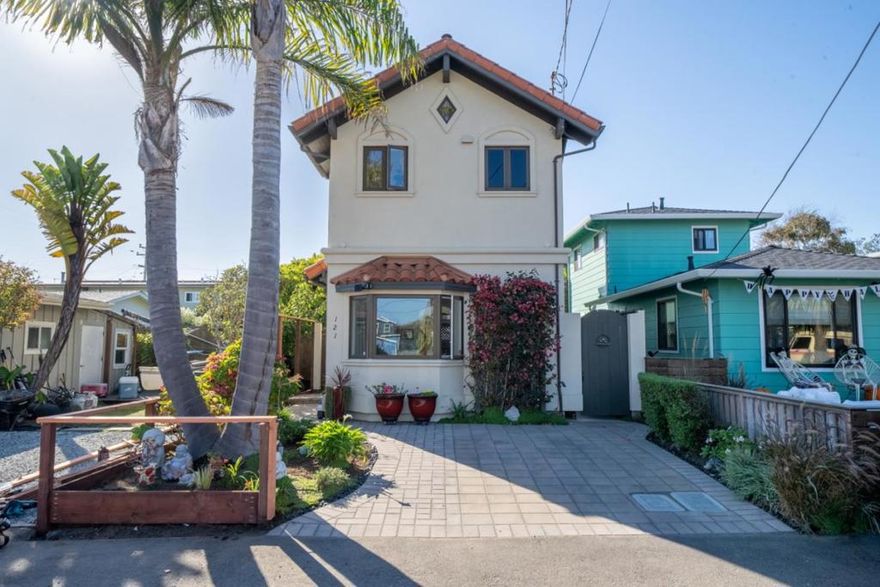 Outstanding location in Pleasure Point, this home is just steps from renowned surf breaks, beaches, and walking paths. Custom designed and constructed in 2004, it features a reverse floor plan, high quality materials and ocean views. Most notable is the distinctive view down Rockview Drive and the ocean beyond. The upstairs living space boasts high ceilings, abundant windows, and a freestanding gas fireplace. The modern kitchen has quartz countertops and new appliances. Enjoy neighborhood and tree views while relaxing on the deck. Downstairs, the spacious primary suite features doors to the patio. The cozy spare bedroom is perfect for a bunk bed, office or creative space. Unique finishes such as beautiful blue tile in the entry, a bay window, and spiral staircase all add character. Radiant heated flooring throughout allows for an even temperature. The fenced, low maintenance yard is perfect for pets and the coastal lifestyle. Rinse off at the outdoor shower and store surfboards on the racks along the fence. Use the finished shed for a workout space or additional storage.  Walk to coffee, or bike to restaurants, shopping or groceries. Located in one of the most sought-after neighborhoods in Santa Cruz, this home is ready for you to just move in and enjoy coastal living.