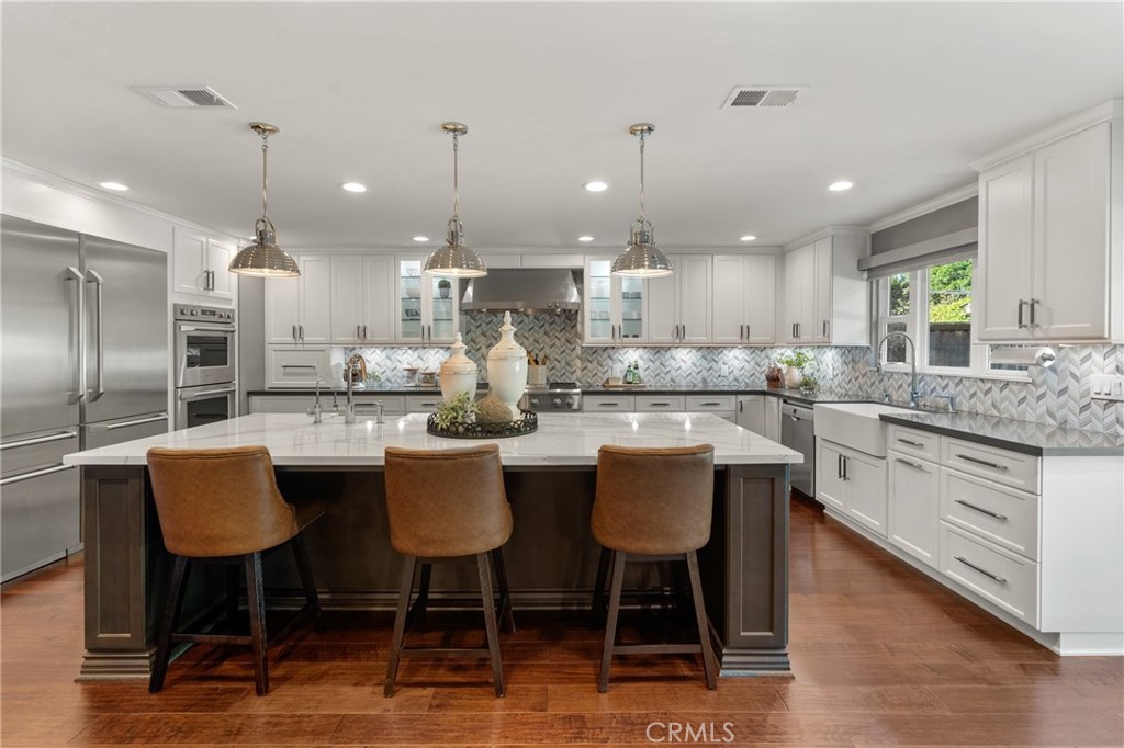 Indulge in the epitome of a single level luxury living in this exquisitely RENOVATED HOME. Boasting 2665 Sq. Ft of meticulously designed living space this 4 bedroom 2 bathroom residence offers unparalleled comfort and sophistication. The rare advantage of a SINGLE LEVEL layout with NO STEPS ensures effortless living. Step inside and be captivated by the expansive OPEN FLOOR PLAN, highlighted by soaring CATHEDRAL CEILINGS. The heart of the home is a spectacular kitchen, a chefs dream come true. Featuring a large seated island, 6 burner gas cooktop + griddle, double ovens, built in GE MONOGRAM REFRIGERTOR & FREEZER, microwave drawer, separate prep sink, filtered drinking water GE MONOGRAM ALPPLIANCES. Bonus, there is a convenient coffee bar with a beverage refrigerator and spacious walk in pantry, two separate trash bins, cabinet organizers. The formal dining area features a fireplace and is currently being utilized as a billiard room. The open living area is inviting and also enjoys a fireplace, cathedral ceilings and another area for family dining. Another special feature is the spacious primary suite featuring sliding doors leading to the outside covered patio and pool area, this suite also enjoys a wonderful bath area with separate soaking tub, walk-in shower and two separate vanities. The advantage of having 4 bedrooms allows for one room to utilized as a home office. Step outside to the very private backyard featuring a 10,000 sq ft level lot with mature trees. Enjoy casual living or entertaining is this very private backyard also featuring a built in LYNX BBQ and swimming pool and spa with beautiful colored lights. The SWIMMING POOL & SPA have just been replastered. Enjoy Al Fresco dining under the covered patio or sun yourself on the open patio. Both sides of the home are spacious and one side is gated for a potential dog run. Beautiful NEW VINYL FENCING surrounds this corner lot home. Enjoy the convenience of an attached 3 car garage with built in cabinets and direct access to the home. This neighborhood is beautiful and has NO HOA! Located near an array of restaurants, this exceptional property is the perfect blend of luxury, convenience and effortless elegance. This is more than a home, it's a lifestyle. Seldom does a single level home without any steps + a 3 CAR GARAGE come onto the market. Don't miss this opportunity.