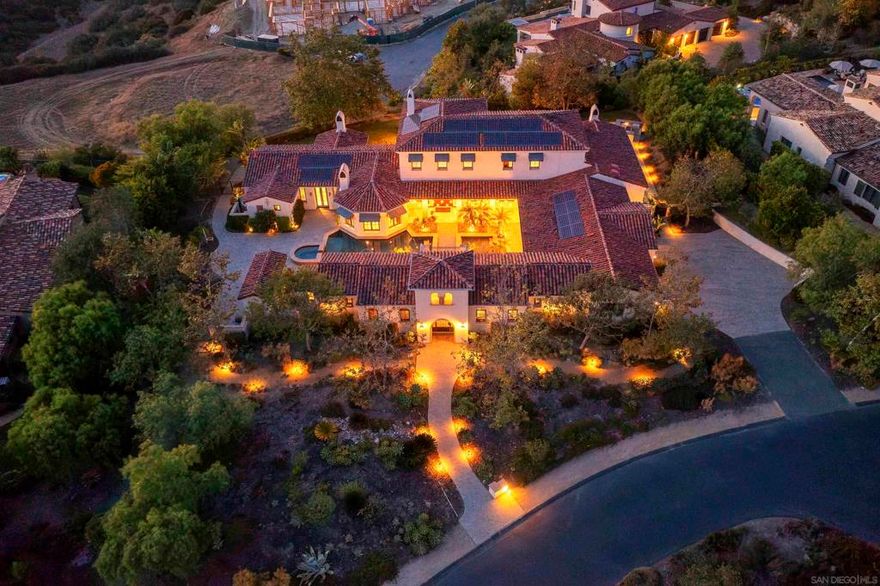 "WowCome" to this meticulously engineered platform for exclusive multi-generational living and uncompromising wellness, all secured behind the 24-hour guard-gates of Santaluz. It is not just a home.   This estate is searching for buyers who requires discretion, integrated luxury, and a life that never stops working for them. This 6,900+ sq. ft. Custom Estate delivers.   Two Fully Private Casitas - Generational Versatility & Separation. Perfect for a secure, detached executive home office, a private suite for a CFO/staff, or independent living quarters for aging parents or adult children. Absolute privacy without leaving the compound. Gourmet Chef's + Butler's Kitchen - Effortless Entertaining. Utilize the main kitchen with its Wolf 6-burner stove for daily living, while the separate butler's kitchen manages catering, prep, and discreet service for grand-scale events. Resort-Style Central Courtyard - The Permanent Vacation. Your private, resort-caliber pool, spa, and multiple fireplaces create a seamless indoor-outdoor hub for hosting unforgettable parties or simply enjoying a tranquil, year-round California escape. Primary Suite with Onyx Bath - Daily Spa-Level Retreat. Escape to a luxurious spa bathroom clad in luminous onyx tile, complete with dual vanities and an expansive shower—a feature designed for ultimate relaxation and rejuvenation. This estate is the destination for those who have achieved the highest level of success and demand a sophisticated, secure, and fully equipped life. Live without compromise.  About Santaluz Established in 2002, Santaluz is one of Southern California’s most desirable luxury communities. Within its gates, you’ll find 836 homes, including 308 custom estates ranging from 2,300 sq. ft. to 23,000 sq. ft. The Santaluz Club is renowned for being a vibrant, social, and family-friendly hub for residents of all ages. Highlights include: Championship golf course with tournaments, men’s and ladies’ leagues, and year-round play. Tennis and pickleball with clinics, lessons, and social groups. Camps and year-round activities for kids, making it an ideal community for families. World-class spa with 7 private treatment rooms, relaxation pool, steam, and jacuzzi. Heated lap pool, swim lessons, and daily fitness classes. A rich social calendar featuring Wine Wednesdays, Chophouse Thursdays, live music Fridays, themed dinners, comedy nights, murder mystery dinners, and family-friendly celebrations like summer BBQs with fireworks. Unique experiences such as “Paws & Pinot” (yoga with your dog followed by wine), holiday brunches, literary luncheons, and book clubs. This estate is more than a home — it’s a lifestyle in one of Southern California’s most active and prestigious communities.