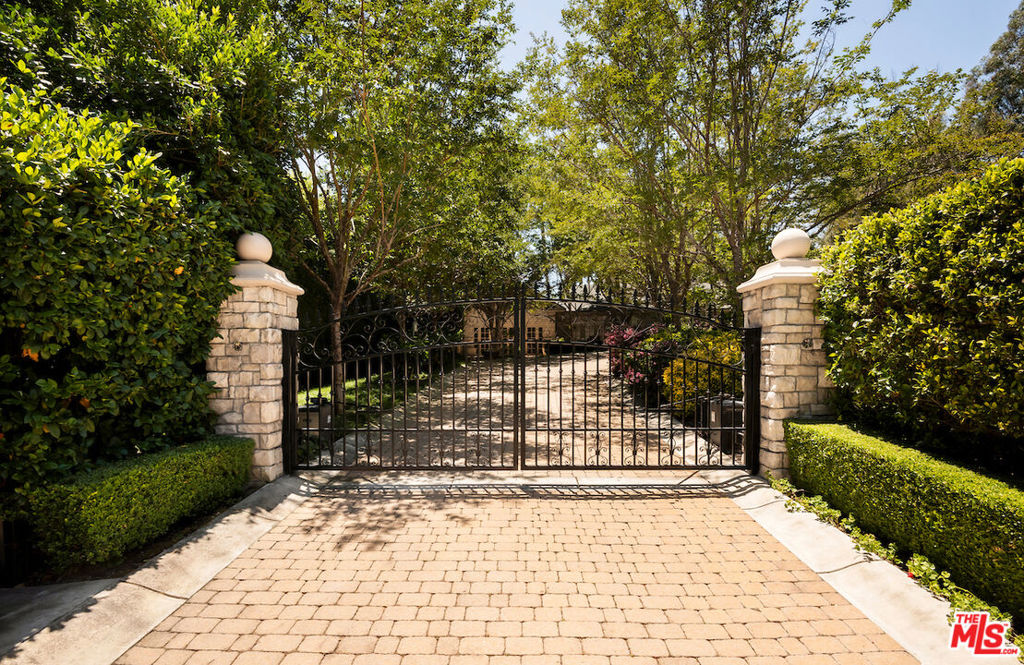 Rare opportunity in prime Beverly Hills to acquire a flat, sprawling and rare 7,885 square foot single story home on an expansive 42,550 square foot lot bordering the iconic Los Angeles Country Club. Extraordinarily private and secure, a grand gated entry and gracious driveway lead to a spectacular motor court with parking for over 20 cars along with a three car garage. The inviting single-story home features 6 bedrooms and 8 baths, entertainer's dining room, theater, and gourmet kitchen with breakfast room on the view. Separate one-bedroom guest house with sitting area and adjoining spacious gym with indoor basketball court. Lushly landscaped grounds include sparkling pool, spa, outdoor kitchen, sports court, and golf course views. Surrounded by major Beverly Hills estates,incredible value for a property of this caliber.